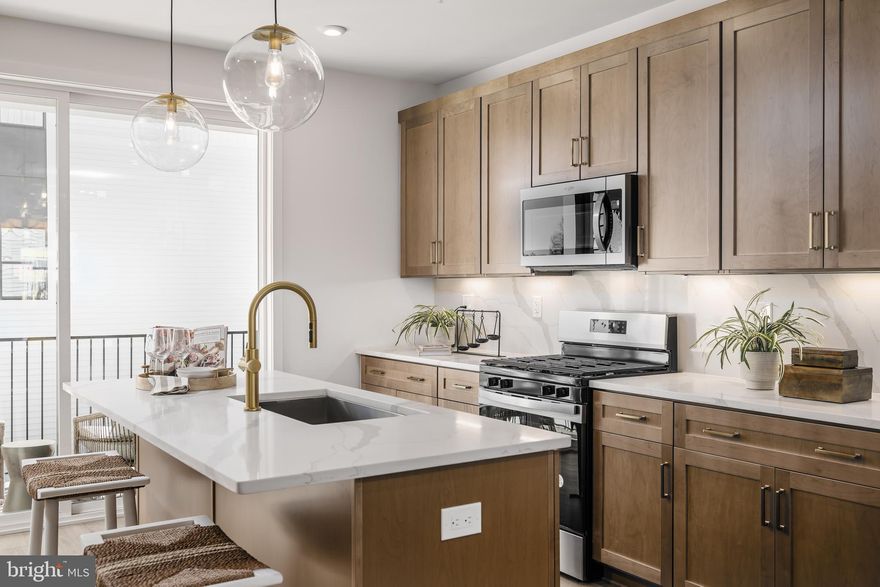 Award winning Louis Woodbury model home offered for sale! This designer feature filled home has been beautifully upgraded with warm, wood toned cabinetry throughout and gold accents to match. The main level is home to a large rear kitchen to maximize your storage space and provide the perfect open layout to your dining room and great room. Upstairs, this home offers a light filled primary suite complete with spa-inspired bathroom and spacious walk-in closet. Just down the hall is your secondary bedroom and hall bath. Complete with bedroom level laundry, including washer and dryer, along with a two-car garage, this is the dream home you have been waiting for. Furniture sold separately, please inquire with the sales team for details. April/May 2026 move-in. Give us a call today to learn more!