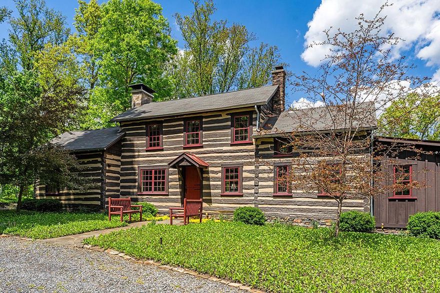 Set on a private ridge above the Shenandoah River with sweeping views of the Blue Ridge and Massanutten mountains, Shenandoah Overlook is a rare weekend retreat where three historic log cabins, a saltwater pool, and acres of landscaped grounds and woodland trails come together in remarkable seclusion.

Originally built in the 19th century on land that is now Shenandoah National Park, all three cabins were relocated here in the 20th century and have since been fully renovated in the 21st century for modern comfort while preserving their character — exposed beams, stone fireplaces, and white-washed log walls throughout.

Whether you’re hosting family and friends, hiking in the mountains, rafting on the river, or simply reading on the back porch as the light moves across the valley, Shenandoah Overlook was designed with family fun and relaxation in mind.   You can also very comfortably work remotely with Starlink internet and strong cell service.   Shenandoah Overlook is a turn-key property where nature and comfort meet — with everything in its place and nothing left to do.

Residences
The artfully restored main cabin features indoor entertaining spaces that blend seamlessly with outdoor living areas.   This comfortable home has plenty of space to unwind, enjoy the view, and even get a little work done in the library.  The other cabins exude charm and privacy as well, with all amenities.   Between all three cabins there are a total of 6 bedrooms and 3 bathrooms to allow for plenty of guests to enjoy the retreat.  Surrounding the cabins are other small log buildings to aid in storage and provide additional charm to the setting.  These include:

Fire Pit –  A metal lined stone faced fire pit near the two guest cabins.
Bank Barn – A log cabin with lots of storage space on two levels.  Ideal for small livestock or storing items safely in an enclosed space.
Cabin Shed – This small log cabin is a place for all pool equipment and lawn furniture tidily stored away.
Pool – An inviting gunite lined saltwater pool with flagstone coping just steps away from the house.  Automatic CoverSafe pool cover for ease of maintenance and safety.

The ultimate in privacy, Shenandoah Overlook is accessed by a long private right of way that opens up to a gentle ridge above the river.  Located along this ridge are the three cabins and outbuildings surrounded by lawns and landscaping and then woodlands beyond.   At strategic points in the forest, viewsheds have been opened up to provide stunning views of the river and the Blue Ridge and Massanutten mountains.  Expertly landscaped lawns and garden areas around each cabin provides outdoor living and playing space for your family, while providing four season garden interest as well.

More of the forested land could be cleared if desired, without compromising privacy.  There are three marked trails that meander through the woodlands.  A terrific feature is also a section of riverfront on the Shenandoah River, accessible via a hiking trail, for fishing, rafting, or just contemplating the beautiful setting.