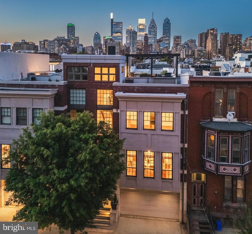 Welcome home to 1631 Christian Street, a dramatic, one of a kind, architectural masterpiece! This rare find runs from Christian St to Webster St and boasts many desirable amenities including a  two car garage, 50ft landscaped yard, two terraces, dramatic steel and wood open rise floating staircase, incredible rooftop deck with out of this world skyline views and so much more!

Enter the home through the double doorway into the stunning bank of ground to roof windows that flood each level with natural southern exposure sunlight.  The custom floating black steel and wood staircase is showcased in this space and acts as a filter of sunlight throughout the home. 

On the first garden level you will find a bedroom with custom built-in desks and book cases, a gas fireplace and a full bathroom. You can also access the extensive manicured yard which features a bluestone patio, landscaped mature greenery and a quaint potting shed.  The two car garage is also accessed on this level.

The main level features a chef's kitchen with a large island, top-of-the-line appliances, and custom cabinetry.  It serves as the central gathering place, nestled between two living spaces and an open dining room. A fireplace, built-in entertainment center, stylish powder room, and an oversized pantry room complete this level.  There is also access to the first of three decks equipped with a gas hookup for grilling and offering glimpses of skyline views. 

On the next level the spacious primary suite features a deck with skyline views, walk-in closet and a stunning soaking tub and walk-in shower.  On this level you'll also find the third bedroom with a full bathroom and the laundry closet.

The top floor reveals a fantastic pilot house/kitchen with all appliances needed to entertain your guests on your dream rooftop deck.  Stepping through sliding doors the spacious deck offers the perfect place to entertain under a starlit night.  Water, gas, and electric outlets allow you to customize the space and keep it cozy during all four seasons. 

The bonus space in the finished basement, complete with a light well for egress, could be a great entertainment room or a home gym. Plus there is a separate space allocated for storage with builtin shelving.

Positioned within walking distance to Rittenhouse Square, Avenue of the Arts, and with proximity to the University of Pennsylvania and CHOP, this home uniquely combines elegance and functionality in one of Philadelphia's most desirable locations. Schedule your private tour today to experience the exceptional lifestyle offered at 1631 Christian Street.