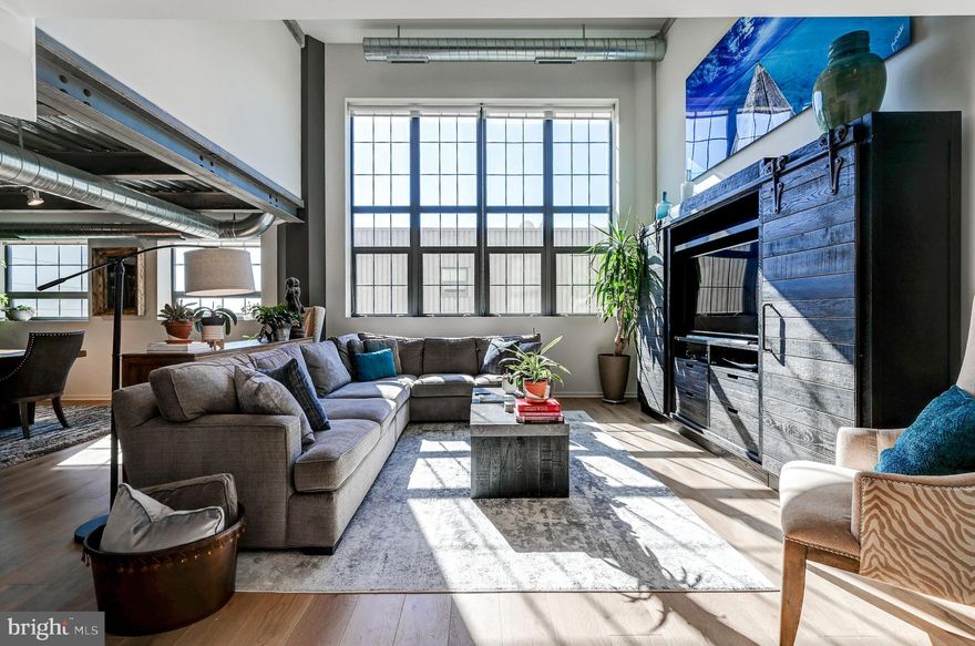 Space, Space and more Space in this very special Industrial Modern Condo at Silo Point.  A rare offering of 3 bedrooms with a loft/ den space plus 3.5 baths.   This condo features more than 2700 square feet of Glass, Original Concrete and Steel. Bin #1120 Boasts a dramatic two story family room flooded with light and a formal dining room of off the eat in kitchen with Viking Appliances,  painted cabinets and light granite countertops.  The entire condo has pristine and newly installed wide plank hardwoods.   The loft is perfectly located between the owners suite and bedroom #2 and features a steel railing that overlooks the two story family room. There are many other updates including the first floor powder room and a newly renovated luxury owners suite bath.  This condo includes 3 deeded parking spaces and a coveted storage space.