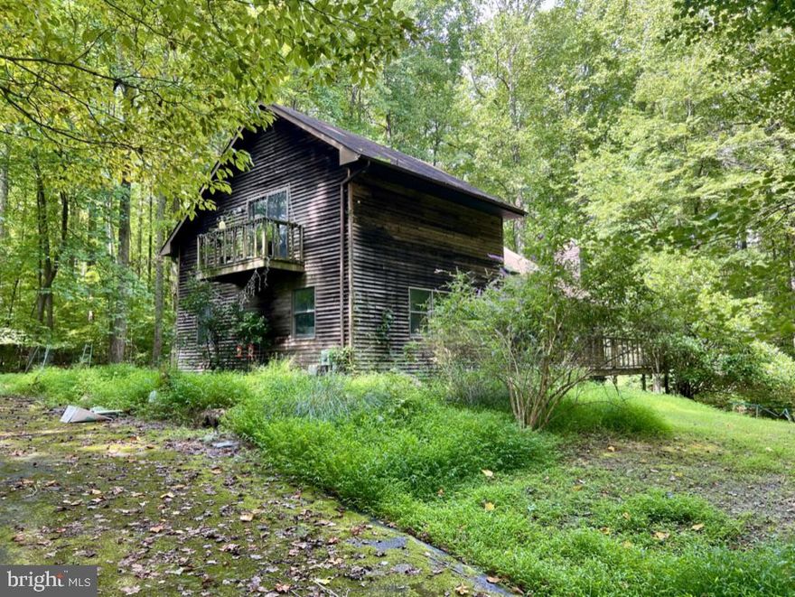 Nestled atop a picturesque crest, this expansive 5.8-acre property offers an unparalleled opportunity for those seeking serenity and privacy. The existing home, while in need of complete rehabilitation, presents a blank canvas for your vision. Alternatively, this idyllic setting is perfect for building a new dream home. 

Surrounded by mature trees and overlooking a tranquil stream, the property boasts breathtaking views and the soothing sounds of nature. Located at the end of a peaceful street, a winding asphalt driveway leads you to this secluded haven.

Whether you're a buyer with a passion for renovation or someone looking to create a custom retreat, this property promises endless potential. The property is being sold as-is, inviting you to shape it into your personal sanctuary.