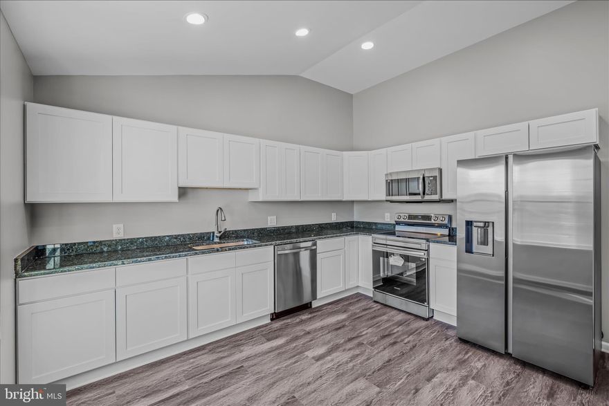 Welcome home to 511 Berry St. in Martinsburg, WV! This beautifully renovated 1919 colonial blends timeless charm with the comfort and convenience of modern living.

A thoughtfully designed main-level bedroom and full bath, along with a brand-new kitchen, anchor the home’s recent addition. The flexible floorplan offers options for a home office, formal living room, or a combined living/dining space—whatever best fits your lifestyle.

Enjoy ceiling fans in all main-level rooms, new carpet and LVP flooring, and recessed lighting throughout. The spacious eat-in kitchen overlooks the backyard and provides a clear view of the Martinsburg High School football field.

No detail has been overlooked—all plumbing, electrical, and mechanical systems have been completely replaced, giving you peace of mind for years to come.

Located on a corner lot within walking distance of Martinsburg High School and just minutes from Route 9 East and I-81, this home is ideal for commuters. There’s plenty of on-street parking for guests, and the yard offers ample space to fence for pets or play.

Upstairs, you’ll find three generously sized bedrooms and a full bath. The cellar-style basement houses mechanicals and provides additional storage.

Don’t miss your opportunity to tour this beautifully updated home—you’ll be amazed by all it offers!