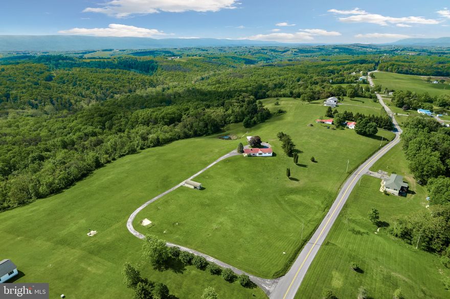 Views, views and more views! Four parcels already subdivided being sold as one totaling 11.18 acres and unrestricted! This picturesque ranch style home sits elevated upon a hill with views of multiple surrounding states. The older charm of this home includes hardwood floors, a beautiful fireplace, a vintage Tappan wall oven/cooktop plus four wells on the property, one which was hand dug in the late 1800's and is in great working order! Spacious layout features a large living room with plenty of natural light, gas log fireplace, 36"+wide hallway as well as staircase leading to the lower level. Basement is fully finished with a fourth bedroom! Detached Amish shed with electric and additional detached building with a covered porch overlooking the pond and mountain views. Many upgrades were completed from 2012-2017 such as a new roof, new heat pump, new water softener and hot water heater, new windows (living and dining room, front basement windows), new bathroom tub/floor and blacktop driveway. See a complete full list of upgrades and dates in documents. Minutes away from War Memorial Hospital and downtown Berkeley Springs. Don't miss your chance to own a slice of Heaven in beautiful WV!
SELLING "AS IS". ANY INSPECTIONS DONE SHALL BE FOR INFORMATIONAL PURPOSES ONLY, SELLER WILL MAKE NO REPAIRS.
