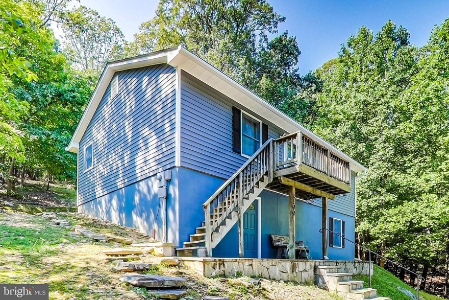 Welcome to this 2 bedroom, 2 Bath home with over 1,880 sq. ft  (tax records inaccurate) of finished space sitting on over a 3/4 acre lot, plus conveys with the adjacent almost 3/4 acre lot 56 for a total of almost 1 1/2 acres combined ,This Home is surrounded by nature preserves yet convenient to major roads and cities. With this home you are nestled in the middle of  a mountain retreat away from everything while Still being close enough to all the amenities the DC metro area has to offer!The beautiful sunrises coming over the valley from the front porch, the private mountain retreat feeling from the back porch and having 2,300 acres of protected preserve with trails right next door. All within an easy commute to anywhere in the DC metro area.”   The upstairs has the kitchen, living/dining room , spacious bathroom with upgraded vanity and laundry along with 2 bedrooms. The downstairs comes with a spacious bonus room for an office, den or playroom, and perfect for a home theater or rec room as well another bathroom.   Lots of improvements including brand new fresh paint throughout the entire interior, new carpet on stairs and upper level, updated kitchen with white cabinets and granite counters and updated bathrooms.   Additionally,  new siding, roof and LeafGuard gutters in 2017; concrete driveway expanded in 2018 and exterior paint redone in 2019. Roads are all well maintained by the community using a voluntary $50 a year contribution that also allows access to the Club House.   High speed Verizon FIOS or Comcast internet already wired and ready to go!    All the conveniences of the area, while coming home to a mountain retreat!