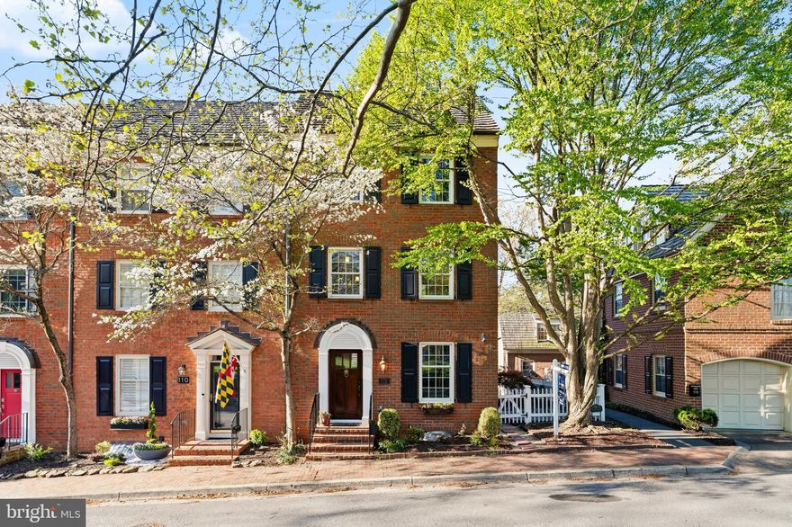 There are addresses in Kentlands that people know — and then there is 112 Kent Square Road. Tucked along the Kentlands Green, steps from the iconic Kentlands Mansion and Arts Barn, this dramatic, sun-drenched end-unit brick townhouse has been owned and lovingly transformed by the same family for over twenty years. And now, for the first time in two decades, it is available — and it is stunning.
From top to bottom, this home has been meticulously renovated — freshly painted throughout, with newly refinished Mahogany hardwood floors, a 2026 kitchen renovation featuring quartz countertops, Bosch stainless steel appliances, and a KitchenAid double oven. The family room anchors the main level, complete with a wood-burning fireplace. Every bathroom has been fully renovated — including a spectacular primary suite, where a double vanity, tub, and walk-in glass shower make every morning feel like a retreat, with sweeping treetop views and natural light pouring in to start the day. Custom Cherry wood doors open to dual closets with ample space and custom organization, plus a separate walk-in closet. A beautifully crafted Cedar banistered staircase connects the levels, leading to four bedrooms, a flexible den with windows and glass French doors — easily a fifth bedroom, home office, or guest room — and four and a half baths. Anderson full tear-out windows, fully functioning Cedar shutters, a 30-year Cedar Shake roof (2013), premium Nichiha Sierra siding, and a freshly updated Cedar picket fence complete the exterior.
There is a private flagstone patio beneath the shade of a grand Cherry tree — adorned with a charming fountain — made for dining al fresco under the lights on a warm summer evening. The side patio, overlooking the canopy of mature trees and the Kentlands Green, is a perfect perch for morning coffee, bird watching, and watching the neighborhood come to life. A detached garage and private driveway round out this exceptional home.
The lower level has been given equal attention: a brand new full bathroom, 2024 washer and dryer, new crown molding throughout, and two separate fully finished spaces that offer endless flexibility — a media room, a guest suite, a home gym, a playroom.
The community pool, the walking paths, the lakes, events at the mansion and theater and art classes at the Arts Barn, the farmers market, the boutique shops and acclaimed restaurants of Kentlands Town Square are all within effortless reach. This is Kentlands living at its finest.