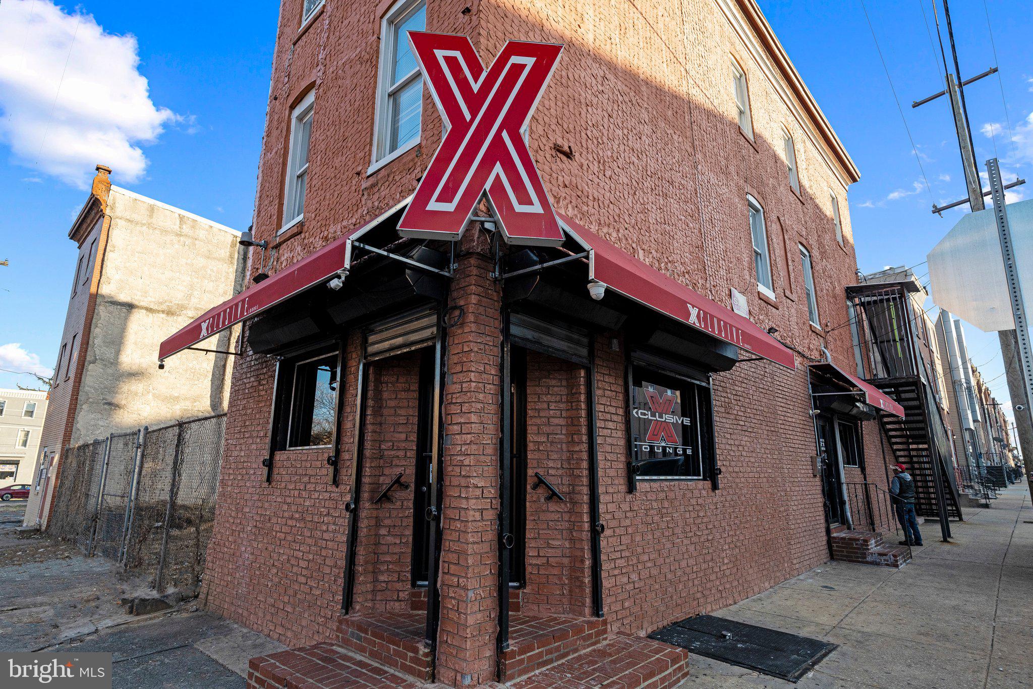 Welcome to this turn-key operational bar in the heart of North Philadelphia. Here’s your rare opportunity to own a fully operational bar, including real estate, fixtures, equipment, and a liquor license. This well established corner property is situated in a thriving and up and coming area.
In addition to the bar, the property includes two separate income generating apartments located on the 2nd and 3rd floors. Over the years, this popular establishment has been thoughtfully upgraded to create a welcoming and enjoyable experience for patrons. Whether guests want to catch a game, try their luck on the slots, play pool in the spacious game area, or relax with friends while listening to their favorite music, Xclusive Lounge offers it all.