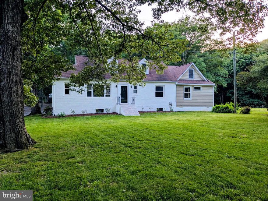 Discover this truly charming country retreat set on a partially wooded 4-acre lot, just 15 minutes from Fredericksburg. This unique home offers 4 spacious bedrooms, 2 full bathrooms, an office area, and ample indoor storage. The property is equipped with multiple storage sheds, a carport, and two oversized detached garages with tall ceilings—perfect for workshops, vehicles, or versatile use. A back shed features additional storage, a dog run, or space for a chicken coop. The long horseshoe-style driveway ensures plenty of parking and easy access. Step inside to find freshly painted interiors, gorgeous hardwood and LVP flooring throughout the main level, and a beautifully remodeled kitchen with solid wood cabinets, granite countertops, a double sink, and stainless steel appliances. Enjoy the bright and airy sunroom with vaulted ceilings, large windows, and dual ceiling fans. The main level includes two generously sized bedrooms, a dedicated office area, and a spacious master suite featuring LVP floors, recessed lighting, a walk-in closet with built-ins, and a luxurious attached bathroom with a modern double vanity and elegant tile shower. The hall bath is fully updated with stylish tile work and a contemporary vanity. A full-size laundry room includes a washer and dryer. Upstairs, you'll find two additional large bedrooms with new carpet and hardwood floors. The clean lower-level basement, freshly painted with epoxy flooring and walk-out access, offers excellent space for a home gym or storage. Recent updates include a 2-year-old well pump, 5-year-old HVAC, 10-year-old roof, 2017 windows and septic system, new stainless steel appliances, and new washer and dryer. This is a rare gem that blends country living with modern comfort ***Seller has an active Real Estate License in Virginia***