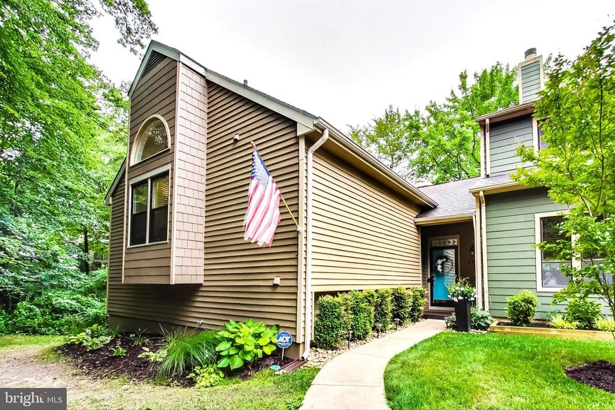 This stunning 4 bedroom, 3.5 bath end unit townhome with over 2,300 square feet of living space in sought after Woods Landing will not last long!  The spacious split-level floor plan features a lower level with 3 generous sized bedrooms, 2 full baths, an open flex space, and separate bonus room with a sliding glass door that leads to the lower level deck- perfect for a family room, movie room, or office! You will find hardwood flooring throughout the entire upper level. The open living room boasts a skylight and vaulted ceiling, a pellet stove, and sliding glass door that leads to the wrap-around deck overlooking a peaceful & private wooded setting. The gorgeous kitchen was just renovated in 2020 with dolomite countertops, a large island with stool seating, ample cabinet space, soft close drawers & cabinets, a pantry with pull-out shelves, pendant lights, white subway tile backsplash, and so much more! In the spacious dining area you will also find a second sliding glass door leading to the deck, as well as a beautiful wood-burning fireplace, perfect for hosting holiday dinners! The half bath off the kitchen was also renovated in 2020! French doors lead to the HUGE main level primary suite with a vaulted ceiling, separate sitting area that could also be used as an office, two closets (including one walk in!), double vanities, and tiled bathtub. This home has been meticulously maintained and updated throughout-  pride of ownership truly shows! The HVAC was replaced in 2014 and has been annually serviced (last serviced and inspected in June 2023). The dryer vent & pellet stove have been serviced and cleaned annually. New carpet in the entire lower level was installed in 2021.  All windows and 3 sliding glass doors were replaced in 2007, and the windows will come with a 10 year transferable warranty to the new owner! The roof, sklylight, gutters, and downspouts were all replaced in 2016, with a 30 year shingle warranty for the roof. Sellers are offering a one year home warranty for the new owners as well- this home is truly ready for its new owners to move in and enjoy! This sought after neighborhood showcases a boardwalk walking trail for its residents to enjoy, a playground, fenced in dog park, tennis & pickle ball courts, and a boat trailer storage lot! Being only minutes from route 50 makes for an easy commute, and it is only 5 minutes from Sandy Point Park & 15 minutes from downtown Annapolis! Do not miss out on the opportunity to own this amazing home! Virtual 3D tour is available!