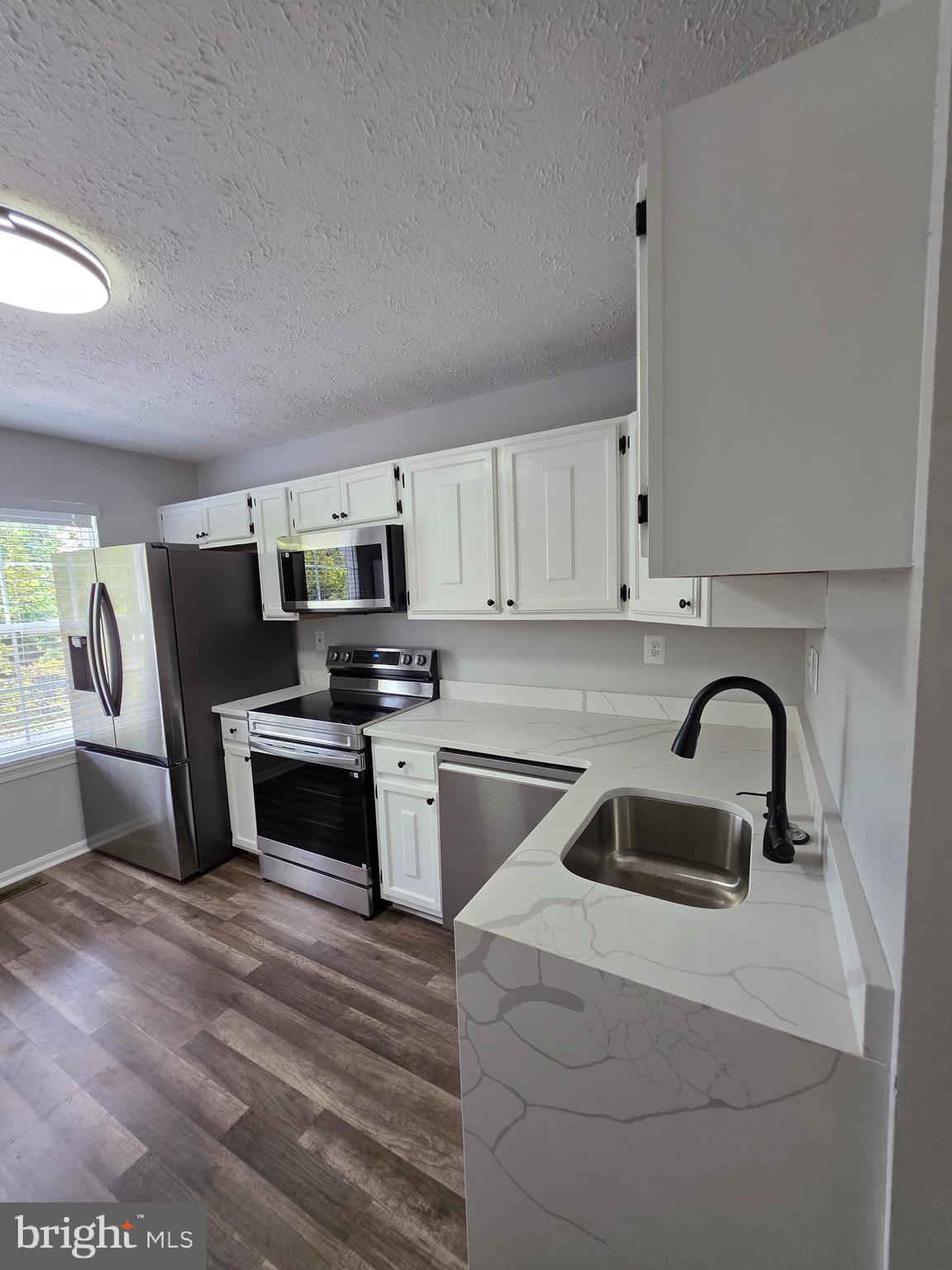 Fully renovated, new ceiling fans in bedrooms, recessed lights. New Samsung stainless steel appliances in kitchen: very quiet dishwasher, dishwasher, microwave and french door refrigerator. New Calcutta gray quartz countertops. new vinyl plank floorings. New hardware throughout. New heat pump. New light fixtures.