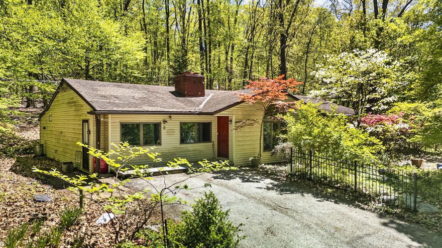 Welcome to 230 Jug Hollow Road! Nestled in a peaceful, wooded setting, this spacious 4-bedroom, 2.5-bath ranch oﬀers a fantastic opportunity to create your dream home. The flexible floor plan features a large living room with hardwood floors, a fireplace with wood burning stove insert, handcrafted built in bookcase, skylight, and a bright foyer highlighted by a dramatic arched window. There is an additional family room, also with fireplace, a cedar lined closet, and a secret closet with access to the attic. The kitchen and dining area provide plenty of space to redesign and customize to your taste. The bedroom wing includes a master suite with a private powder room and access to a shared bathroom. There are three additional bedrooms, one of which has private access to the shared bathroom, and a full hall bath.
Additional features include a dedicated laundry room, pantry space, arts and crafts room or studio with skylight, and a large unfinished basement oﬀering abundant storage and potential. Outside, enjoy the private, 2.4 acre wooded lot! In front of the house is a slated patio for enjoying the woods and the garden, planted by the owner. In spring this area is covered with gorgeous azalea, mountain laurel, wisteria, and rhododendron blooms. The highlight of the front garden is the beautiful blooming magnolia tree. Near the front door is a Japanese Maple tree. Rhododendron bushes also grace the back of the house, visible through the French doors in the dining room. The side of the house has a second patio area, and a one room play house, wired for electricity, built by the owner’s father. Wildlife visitors are frequent, from deer,
squirrels, and chipmunks, to many varieties of birds which change with the seasons. The owners and builders of the house were artists with a unique vision and an appreciation for the beauty and serenity of their homes' location. 230 Jug Hollow was one of the very first homes built in this now very desirable area. With great bones, generous room sizes, and endless renovation potential, this home is ready for your vision and updates to make it truly your own.