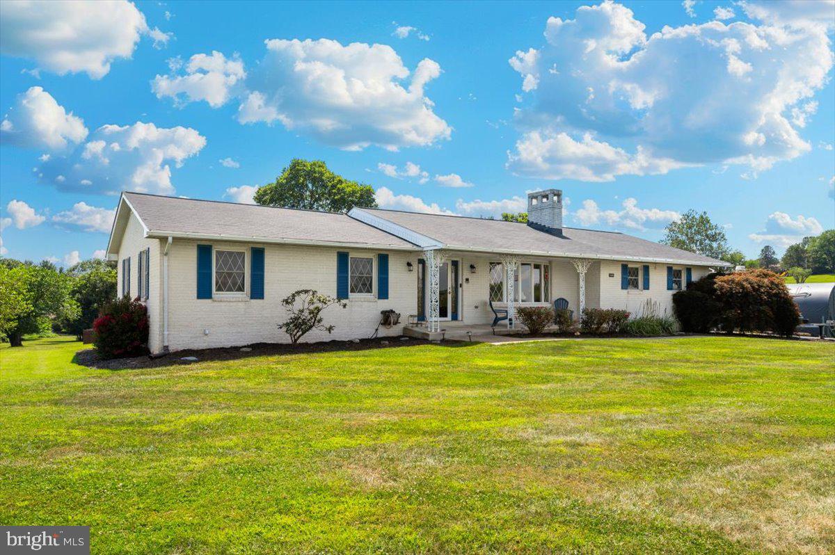 So country, yet so close in! Beautifully-maintained brick ranch home on nearly 2 acres just outside the town limits of Boonsboro, MD. As you pull in the drive, you will immediately notice several peach trees and parking space for boat, rv, or other large vehicle! Not to mention the attached 2-car garage and the free-standing 1-car garage (with electric)! Just a few steps away, the walkway leads to the large front porch. The entry ushers you into a large living room just to the right with wood-burning fireplace. Straight ahead leads you to the dining room with open concept to the large kitchen. The kitchen has beautiful solid wood cabinetry, breakfast bar, Corian counters, and stainless appliances. The dining room has sliders leading to a spacious sunroom with ceramic flooring and baseboard heat--central heat and air provided throughout rest of the home with hvac system. Just beyond the kitchen is a mud room/laundry room and half bath. The mudroom also provides access to the attached, two-car garage. Heading down the hall (to the left of the entry) are 3 bedrooms and a hall bath. All are of good size. Just beyond the sunroom is a beautiful deck with gazebo overlooking the fenced area of the yard (with firepit). Whether grilling, dining, entertaining or just hanging out, this is a great place to spend time. The property extends quite a bit beyond the rear fence in all directions! The custom-made 12x20 shed/workshop (2024) sits towards the right rear of the property. The partially-finished lower level is home to the owner's mancave, but would also be an ideal woman cave/bat cave/sanctuary. From wood-burning fireplace, rustic walls, to pool table, to bar with antique fridge that makes beverages ice-cold. It says come spend some time. A separately-accessed section of the basement is dedicated to large storage space and mechanicals. Owners have lovingly maintained and improved this property. It shows. It's pretty from the front, and gets better and better! Be sure to check out the roof replaced in February of 2024--those skylights are new too! No Boonsboro town taxes. No HOA. Close to amenities and major travel routes.