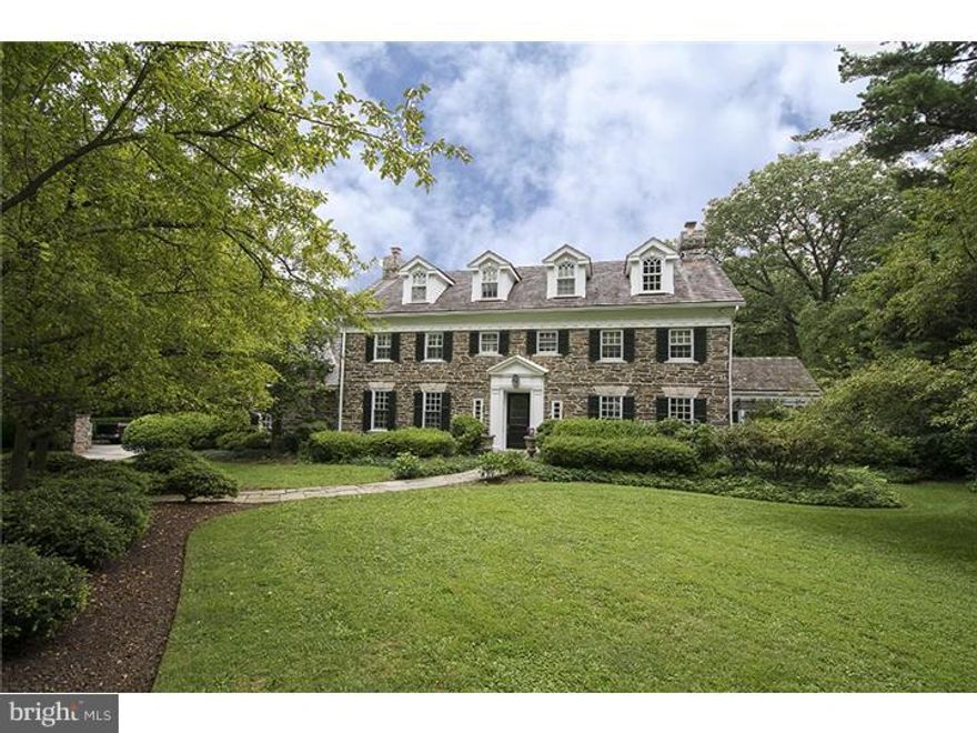 Stately stone colonial on deep 1.5 acre lot offers timeless finishes on one of Bryn Mawrs most prestigious streets. Classic center foyer floor plan offers gleaming hardwood floors on three levels with generous formal and informal spaces and updated chefs kitchen with white cabinetry and cashmere granite counters. Four bedrooms in the main house each with ensuite bath including a recently expanded deluxe master retreat which offers unparalleled privacy and best quality appointments. Guest house has separate entrance and is located over top of the three/four car garage, outfitted with full bath and small kitchen. Exquisite grounds with centennial plantings, beautiful pool with blue stone terracing and "cabana" with half bath combine to create ideal outdoor space for family or entertaining.