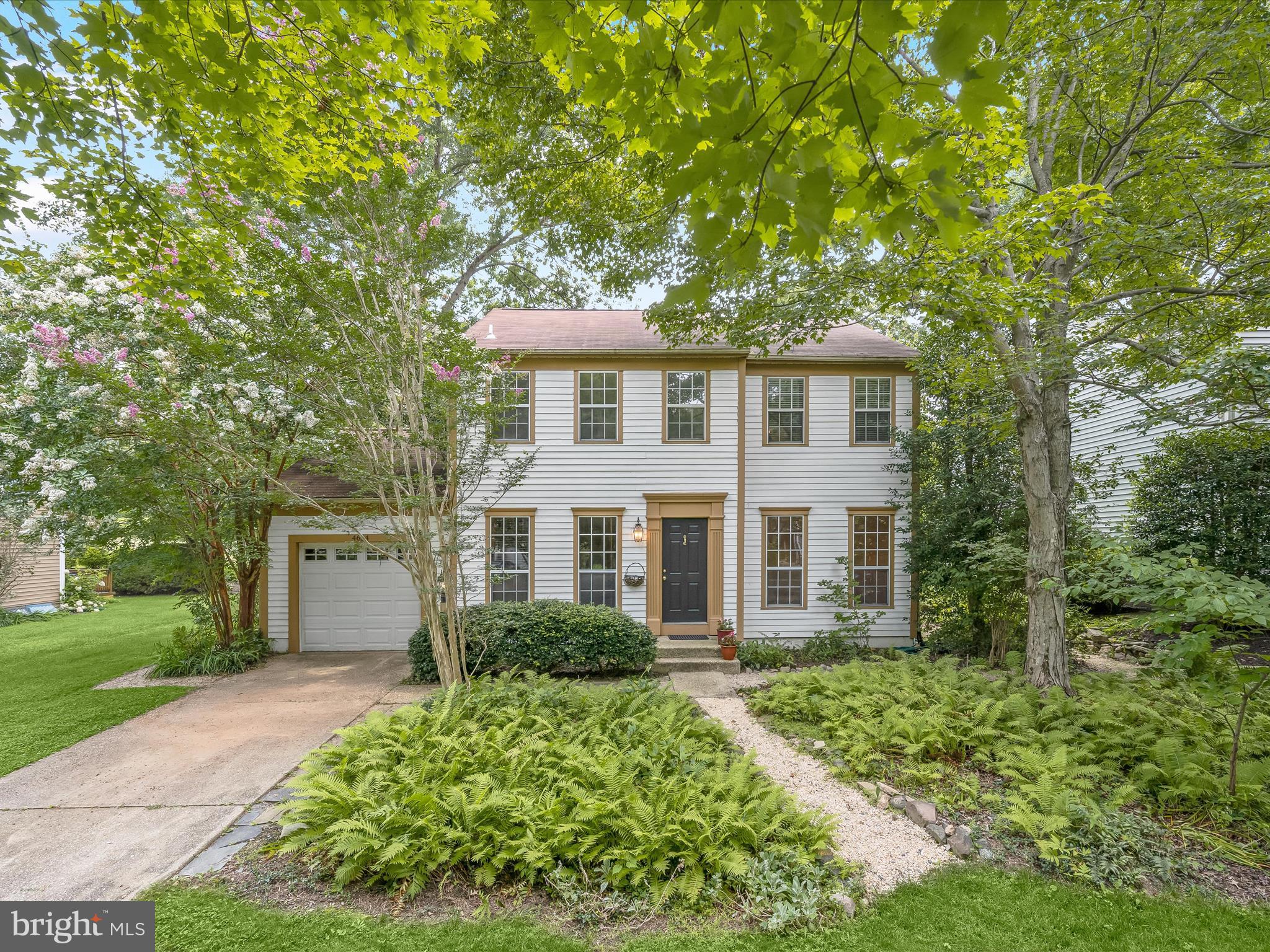 Tucked away in a sought-after Ellicott City community and backing to open common space with scenic hiking trails, this lovingly maintained Colonial blends charm, character, and thoughtful updates throughout. Highlights include a newer roof, HVAC, windows, flooring, carpet, and more. The main level showcases refinished yellow pine flooring, and the formal dining room features stunning reclaimed 1840s oak log wood. The updated kitchen offers rich wood cabinetry, bamboo countertops, and opens to a cozy sitting area with built-in bookshelves. A sun-drenched sunroom with soaring cathedral ceilings and bamboo floors provides two exits to the beautifully landscaped, fenced backyard. The spacious living room features wide plank wood floors and a built-in corner China cabinet, while a powder room is conveniently located off the foyer and near the garage entry. Upstairs, new carpet flows throughout. The primary suite includes a walk-in closet and a large en suite bathroom with dual vanity and a shower. Two additional bedrooms and a full hall bath complete the upper level. The lower level adds even more space with a recreation room, a bonus room, laundry area, and abundant storage. Outside, enjoy your own private oasis with lush landscaping and a charming arched gate that opens directly to the open common grounds and trails. Ideally located near major commuter routes, shopping, dining, and entertainment, this home is the perfect blend of serenity and convenience. The offer deadline for this property is Monday, August 11th at 2pm.
