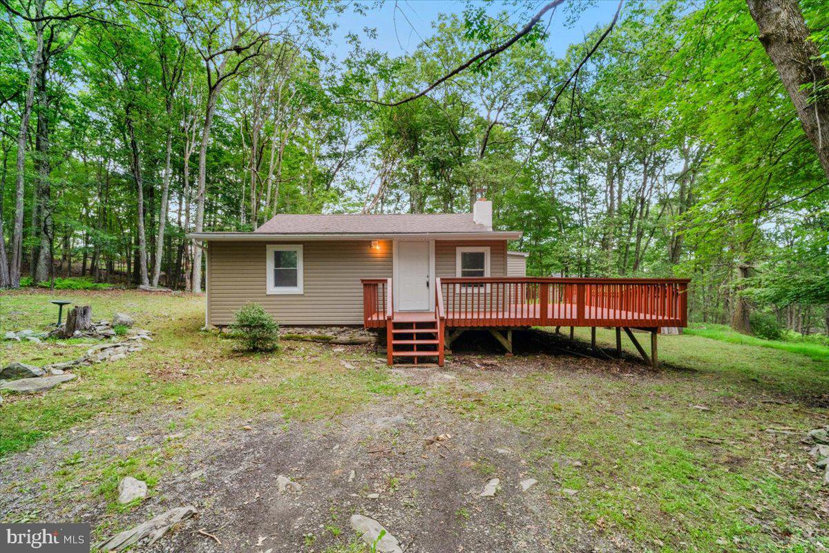 This beautifully updated residence offers modern comfort and style in the heart of the Poconos. Fully renovated, this home boasts all-new flooring, sleek countertops, efficient electric baseboard heating, contemporary doors, and energy-efficient windows, ensuring a fresh and inviting atmosphere. Every detail has been thoughtfully upgraded to provide a turnkey living experience. Keep cozy and warm all winter long with your working wood fireplace and your pellet stove. Each room has baseboard heating with its own thermostat for those extra cold nights. Spend lazy summer evenings on your 300+ square foot deck. The roof, less than 3 years old, and the septic system, replaced around 2008, offer peace of mind and long-term reliability. Nestled in the scenic Pocono Mountains at the end of a quiet lane, this home is minutes from premier attractions. Enjoy outdoor adventures at Bushkill Falls, the "Niagara of Pennsylvania," or hit the slopes at Shawnee Mountain Ski Area. Explore the charming shops and restaurants in downtown East Stroudsburg, or take a scenic hike in the Delaware Water Gap National Recreation Area, all just a short drive away. Don’t miss this opportunity to own a move-in-ready gem on a quiet secluded lot!
Use Bear Road and NOT Halfmoon Ln to access the development. Halfmoon Ln is not maintained.