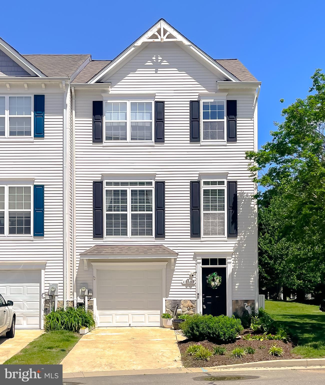 Welcome home, where exquisite water views draw you immediately to this lovely end unit town home! Enter at the ground level, where LVP flooring and an open foyer invite you in to this charming home. Wander through to the expansive hobby room/fourth bedroom, which is a crafter's paradise. This level also features a 1/2 bath and laundry area as well as the single car garage. The mid-level is the entertaining space. The bright living room opens nicely to the kitchen, sitting area and bar, with hardwood flooring flowing throughout. Granite counters, tall maple cabinets, stainless steel appliances and beautiful water-views make this area ideal. The wood burning fireplace adds the perfect ambiance, whether whipping up a delicious meal or sitting quietly reading a book. Step outside on the deck to unwind after a long day and listen to the waves of the Chesapeake Bay lap ashore to the communities private beach. The upstairs has two guest bedrooms and a newly renovated hall bath. The owner's suite, with its exquisite water views, has a generous walk in closet and newly renovated private bath. The lower level outside space is private and can be enjoyed from the covered patio, a perfect spot for gardening or relaxing in a hammock. This lovely well-maintained home has lots of updates and improvements to include a new garage door (2017), new s/s appliances w/gas range ( 2018), new roof (2020), new hvac (2021), new washer and dryer (2023), new refrigerator (2024), as well as replacing 11 sealed window units, new mirrors, flooring and vanity fixtures in full bathrooms. Less than five minutes to PAX Gate 3, dining and shopping as well a short two minute walk to the private community beach this lovely home provides the essence of waterfront living. Come out to visit soon and make this one your new home just in time for warm weather!!