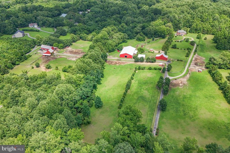 Equestrian Lifestyle with Refined Living at Thanksgiving Farm. Nestled in the rolling countryside of bucolic Lothian, Maryland, Thanksgiving Farm is a premier equestrian property designed with both the serious horse enthusiast and discerning homeowner in mind. This exceptional 2005 custom brick colonial, designed by renowned architect William E. Poole, offers over 3 finished levels of elegant living space—including 4 spacious bedrooms, 3.5 baths, and a stunning club room perfect for entertaining or relaxing after a day in the saddle. Set on an expansive and thoughtfully developed property of almost 40 acres, the farm features more than 40 stalls across four barns, each offering a minimum of 10 stalls—ideal for private operations, or  training programs, or boarding facilities with a potential gross income of $30,000 per month. A studio apartment attached to the indoor arena and a tiny house with one of the barns provide flexible housing options for staff, or guests. Equestrian amenities are truly exceptional. The 72' x 132' indoor arena, built in 2005, boasts premium sand footing treated with magnesium for dust control and blue stone blend for optimal traction—perfect for year-round training. There is also a three-bay over-sized detached garage (27' x 36'), ideal for farm vehicles, trailers, and additional storage. The property is supported by two wells and two septic systems—one original to the property and another installed for the newer main residence—ensuring reliable, modern infrastructure. Located just 10 minutes from the PG Equestrian Center, and close to shopping, dining, and major commuter routes, Thanksgiving Farm offers the perfect blend of rural tranquility and urban convenience. This is a rare opportunity to own a fully equipped equestrian estate in one of Maryland’s most desirable riding communities. Be sure to check out our 3D virtual tour. Shown by appointment only.