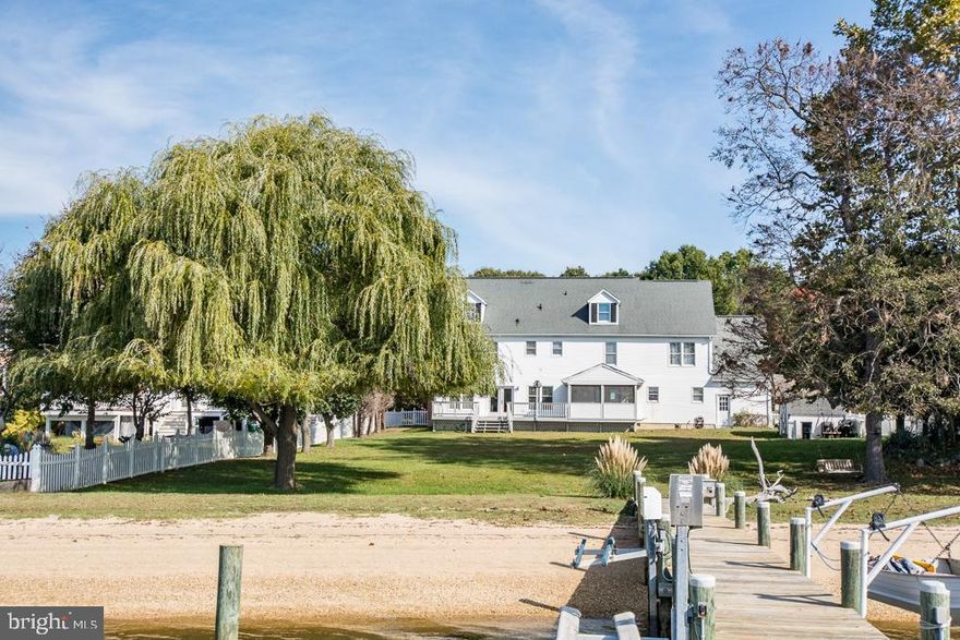 The home you have been waiting for! Amazing waterfront home with room for everyone! Beautiful sandy beach, pier with deep water, boat lift and 2 jet ski lifts, sunsets and more. Main level of home has eat-in kitchen, half bath, cozy family room w/ fireplace, screened porch, study, formal living room and formal dining room. Upper level has 5 bedrooms and 2 baths and THIRD level offers fabulous game/rec room with wood burning stove, bar, full bath and workshop. Home is being sold furnished so move right in and let the games begin! Property is being sold strictly "as is".