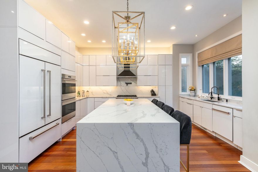 An Exquisite Washington Square West Residence
A rare, 29-foot-wide double lot in the heart of Washington Square West sets the stage for this extraordinary nearly 4,200 sq. ft. turn key contemporary residence. With its timeless  brick façade, oversized bay windows, Brazilian hardwood floors throughout, and gated courtyard entry & 2 CAR PARKING the property offers a commanding  presence . Once inside, meticulous updates and thoughtful design unfold in every direction, creating a home equally suited for gracious entertaining, comfortable family living, and the quiet enjoyment of refined city life on elegant tree lined street .
At the core of the main level, a fully redesigned chef’s kitchen takes center stage. Outfitted with a classic Wolf range and wall ovens, panel-ready Sub-Zero refrigeration, Bosch dishwasher, immaculate quartz countertops, and every modern convenience, it is as functional as it is elegant. An expansive island with breakfast bar flows seamlessly into the dining and living areas, creating a natural centerpiece for daily life and a setting where gatherings, both large and small, feel effortless. Wide windows bathe the space in natural light, highlighting the home’s impressive scale and subtle architectural details.
The home’s rare width and ceiling height are felt on every floor, offering generously proportioned rooms and a sense of openness seldom found in city living. Multiple living areas allow for flexibility - whether as formal entertaining , casual family retreats, or creative spaces tailored to the owner’s lifestyle. A full-height elevator provides ease and comfort, connecting every level, from the lower-level in-law/au pair suite to the stunning rooftop terrace with sweeping views of the Philadelphia skyline.
The private quarters are equally remarkable. With five bedrooms and four and a half bathrooms, the residence adapts to every stage of life and style of living. The second floor primary suite serves as a elevated sanctuary , with space for a private sitting area, abundant natural light, a spa-like bath, spacious walk in closet and a private balcony that offers a place of calm and indulgence. An adjacent room off the primary suite and den overlooking the formal living room can serve as a perfect office, informal living room, library, or a convenient nursery and playroom, to name a few. Additional bedrooms provide comfort and privacy for residents and guests alike, while dedicated spaces include an upper-floor laundry room and an abundance of well-appointed closets and storage.
Outdoor living is as thoughtfully designed as the interiors. A gated front courtyard welcomes with elegance and privacy, while the expansive rear patio and rooftop terrace provide opportunities for dining al fresco, quiet reflection, or lively entertaining against the backdrop of city lights.
Every detail of this residence reflects a balance of history and modernity, permanence and comfort. The timeless architecture grounds the home in tradition, while careful updates ensure it meets the demands of contemporary living. Its scale, width, and flexibility allow it to function beautifully for both intimate daily life and grander occasions. The property is complete with the convenience of a gated driveway, oversized attached garage with EV charger, and an additional private staircase to the lower-level in-law suite. Perfectly located within the sought-after McCall School catchment and just seconds from the finest dining, shopping, and cultural experiences of Washington Square West , this home embodies the essence of Philadelphia living at its most distinguished.