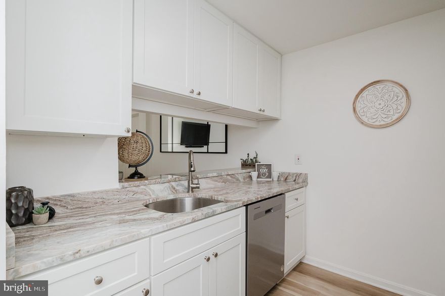 Completely renovated and move-in ready! This beautifully updated 2-bedroom, 2-bath condo in Cromwell Fountain was completely renovated in 2023 and offers stylish, modern living in an unbeatable location, just 20 minutes from BWI Airport and close to major commuter routes and public transportation.

Step inside to an inviting open floor plan featuring luxury vinyl plank flooring, a spacious living area, and a cozy gas fireplace perfect for relaxing or entertaining. The beautifully updated kitchen showcases crisp white cabinetry, sleek 2023 stainless-steel appliances, and stunning marble-look countertops that bring warmth and character to the space. Enjoy the convenience of an in-unit washer and dryer and unwind on your private balcony.

Both bedrooms are generously sized, and the updated bathrooms feature modern marble-look tile, sleek vanities, upgraded fixtures, and spa-style shower panels with rainfall heads and body jets, creating a luxurious, contemporary feel throughout. Major systems have been well maintained, including an HVAC system from 2017, an A/C compressor only 4–5 years old, and a water heater less than 6 months old, offering peace of mind for years to come.

Community amenities include a sparkling outdoor swimming pool, tennis courts, sidewalks throughout the community, and secure building entry.

Whether you're a frequent traveler, a first-time buyer, or simply looking for a move-in-ready home with modern touches, this condo will check all your boxes. Flooded with natural light and packed with high-end updates, this stunning condo stands out from the rest!