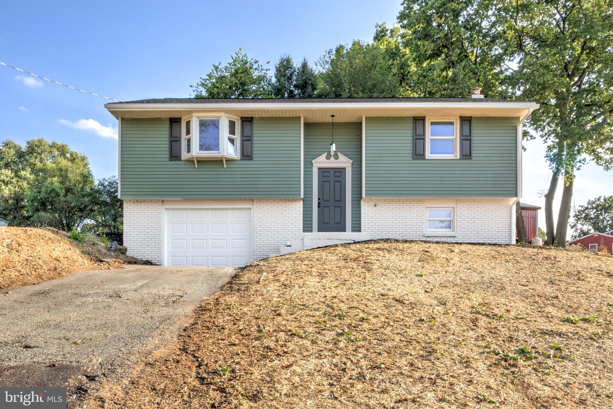 Welcome to 1198 Iron Bridge Rd – a beautifully renovated 3-bedroom, 2.5-bathroom split-level home where modern updates meet everyday comfort. Step up to find a bright and open living space featuring all-new luxury vinyl flooring and plush carpeting. The spacious living and dining areas flow seamlessly into a fully updated kitchen, complete with sleek white cabinetry, designer tile backsplash, new stainless steel appliances, and a large center island—perfect for both meal prep and entertaining. Double glass doors lead to a brand-new deck and a private rear yard, ideal for outdoor living. The main level features two bedrooms, including a primary suite with a fully updated en-suite bath, showcasing a new vanity and a beautifully tiled walk-in shower. A second full bathroom offers a new tub, stylish tile surround, and updated fixtures to complete this level. Downstairs, enjoy an additional living area with a cozy brick fireplace prefect for an entertainment room or just relaxing. A third spacious bedroom, a laundry room, and access to the one-car garage complete this level. With a brand-new HVAC system, a fresh resealed driveway, and a NEW ROOF, this home is move-in ready and packed with value. Don’t miss your chance—homes like this don’t last long!