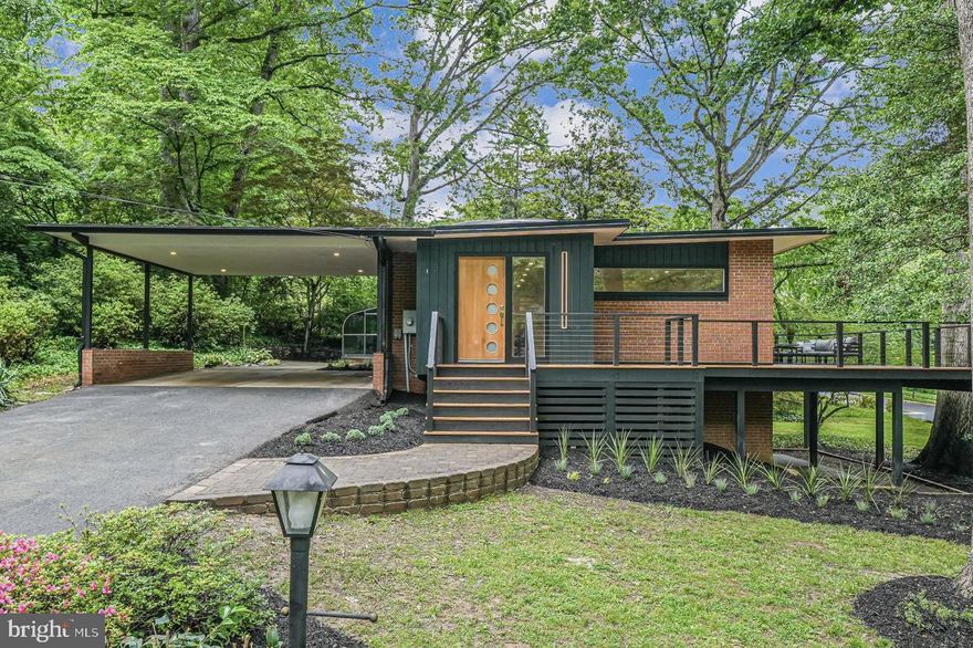 MID-CENTURY MODERN WORK OF ART. Lake Barcroft. Must see, fully remodeled and gorgeously designed by MM Design Co. Striking exterior elevations and design from all angles. Beautiful butterfly roof on double-wide MCM carport.  This 5 BR / 3 Full BA / 3134 sqft has year-round LAKE VIEWS and a very short walk to one of Lake Barcroft’s 5 private sandy beaches. MM Design Co blended MODERN FINISHES with MID-CENTURY MODERN ARCHITECTURE that pay homage to the charming homes throughout this private lake community. This home feels like new construction with almost every inch, inside and out, thoughtfully redesigned and renovated. Enter the home through the repositioned entry and new geometric design front door to find tons of natural light filling the OPEN CONCEPT main level. The gourmet kitchen has a 10.5 ft island, new modern warm oak custom cabinets, beautiful quartz countertops, a 36” Professional Gas Range, and Stainless-Steel Appliances. Modern dimensional backsplash and elegant MCM light fixtures were selected for island pendants and the dining room fixture, and a custom COMMISSIONED MCM METAL RAILING provides additional differentiation and design.  Just off the open living space is a new and expanded 450 sqft deck with modern cable railing. New WARM OAK EGININEERED HARDWOOD FLOORS on both levels. The main level Primary Suite with Walk-In Closet also has an inviting GLASS SOLARIUM accessible from the Primary Suite or the back of the home. The stunning Primary Suite Bathroom features a custom oak vanity with quartz countertops and large glass frame walk-in rainfall shower. A spacious Bedroom 2 is also on the main level which also has a Walk In Closet, as well as a beautifully renovated hall bathroom with custom vanity and quartz countertops. Downstairs to a bright, sun-filled family room with walk out access. On this level you’ll find 3 more very generously sized Bedrooms, a laundry room with new Samsung washer & dryer, as well as fully renovated Bathroom 3 with custom oak vanity, and large walk-in shower. New Sierra Pacific Windows Throughout. New Black Gutters. Membrane Roof. New Sierra Pacific Slider to Deck. Substantially New Plumbing & New Electrical. New 200 AMP Electric Panel. New Furnace & AC.  Substantial Landscaping. New Side Patio. And so much more! Be sure to see the FULL REMODEL FEATURES LIST. Walk to one of Lake Barcroft's 5 sand beaches for swimming, boating, and fishing. Easy access to commuter routes (50/66/495) and Arlington, Tysons and DC. This one-of-a-kind MM Design Co home can be your private Mid-Century Modern oasis, just minutes to shopping, dining, and more!