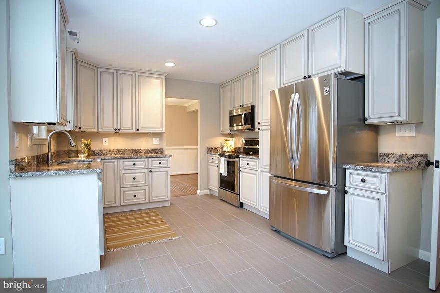 OPEN SUNDAY 1-3. Major Price Reduction, Motivated Seller! Beautifully remodeled colonial featuring gourmet eat-in kit, custom cabs, granite & SS appl. Sep DR, 4 LG bedrooms, 3.5 freshly updated baths, Hwd flrs, FP, new HVAC, finished club rm. Fresh paint, custom moldings, tile flooring, new carpet, 2 car garage, huge deck overlooking beautiful landscape. Spectacular home offering high-end details!