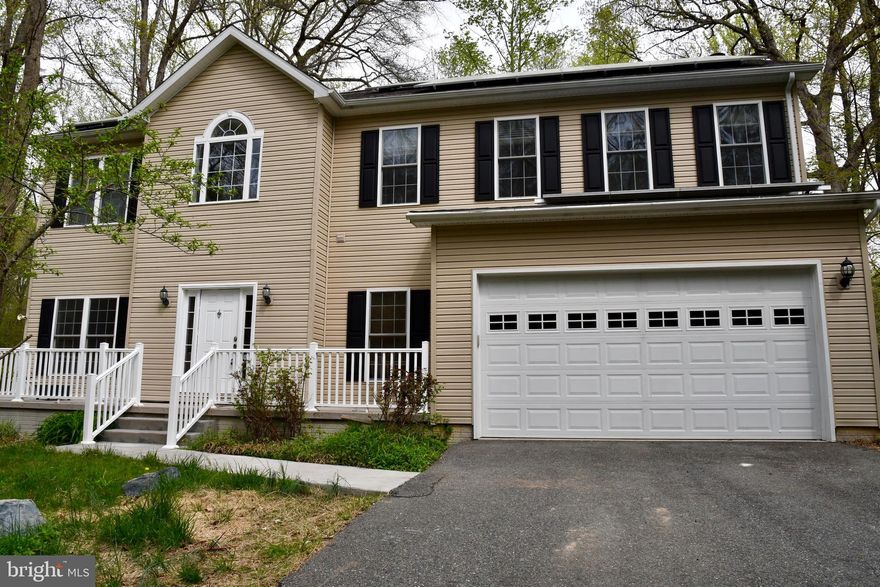 Beautiful Custom built home with 4 BR & 2.5 BA.  This gorgeous property features hardwood floors throughout, NEW CARPET in all 4 BR's, gourmet kitchen with stainless appliances including NEW Refrigerator & NEW Double Oven, granite, cherry wood finished cabinets, ceramic tiled floor with a large relaxing family room & wood burning fireplace. Ceramic tiles in each bathroom with the master bathroom featuring a steam shower, NEW washer & dryer. This home also features a huge brick patio for outdoor entertaining in this quiet wooded lot along with solar panels reducing electricity bills. Come see this Gorgeous Home located right next to Rocky Point State Park. There's nothing left to do but move in!