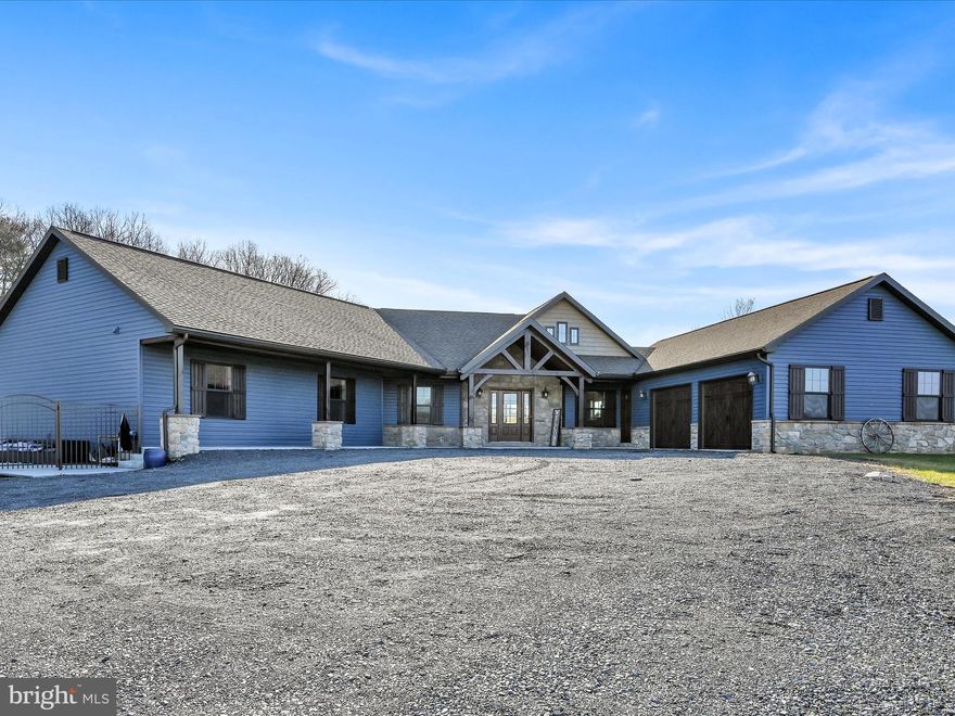 If one floor living and acreage in the country check multiple boxes for you then you MUST see this home.  Nestled off the beaten path this ranch style home on 4.61 acres was newly constructed in 2018.  As you enter through the main entryway your eyes will immediately be drawn to the majestic timber frame and Cathedral ceilings above.  The gorgeous timber was brought in from Tennessee.  Bright and cozy, this open concept living space has so much natural light.  The dining area is spacious and provides plenty of room for  large family gatherings.  The kitchen is a show stopper with a custom island and breakfast bar in a beautiful hue of blue with a butcher block counter.  Neutral cabinetry, granite countertops, custom light fixtures and a large walk-in pantry make this kitchen not only appealing to the eye and functional but  close enough to not miss out on all the family fun.  The sliding glass doors open up to a concrete patio space, perfect for enjoying your coffee in the morning or relaxing in the evening. The primary suite boasts a walk in closet and a spa-like retreat with a soaking tub and tile shower. The five additional bedrooms are spacious with ample closet space. The second full bath features a double bowl vanity and private toilet area. The sitting room could also be used as an office, another bedroom or a hobby/craft room.
The mudroom/laundry area was well thought out with cubbies for coats, bags and shoes.  A half bath here and one just inside the main entrance are conveniently located for a busy family on the go!  The attached two car garage has plenty of space for your vehicles and toys. The two sheds on the property will remain, you can store all of your gardening and yard equipment here.  The fenced in saltwater pool was new in 2020. Imagine relaxing here in the hot summer months!  Don't miss the chance to witness the modern charm and farmhouse elegance of this custom-designed home.  Schedule your private showing today.