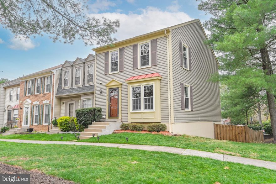 Tucked into the sought-after Colony Park community, this end-unit Coventry model enjoys a premier location and is beautifully sited on a unique lot that offers an expansive side and rear yard—perfect for outdoor enjoyment. Thoughtfully updated and freshly painted, the home welcomes you with a warm, open main-level floor plan featuring gleaming hardwood-style flooring throughout. The foyer opens to a formal living room adorned with a boxed bay window and an upgraded side window, available exclusively in end-unit models. An elegant dining room flows seamlessly into the living room, while a cozy family room nook opens to a refreshed kitchen. The kitchen features white-painted cabinetry, marble-style quartz countertops with gray veining, natural stone backsplash, and a suite of new stainless steel LG appliances.  The hardwood staircase, with a freshly painted black railing, leads to the upper level. The primary suite offers new wide-plank white oak hardwood-style flooring, and an en-suite bath with floor-to-ceiling tile & accent listello detailing in the shower. Two additional bedrooms also feature new flooring, light fixtures, and doors, while the updated hall bath showcases a granite-topped vanity and beautifully tiled tub/shower combo. On the walk-out lower level, a spacious recreation room offers ample natural light, a wood-burning fireplace with brick surround, and direct access to the rear patio. A full lower-level bath and generous storage/laundry space add convenience and functionality.  The fully fenced rear yard, with a newly stained wood platform deck and extended stone patio, is ideal for entertaining. Residents enjoy access to exceptional community amenities, including an outdoor pool, tennis & basketball courts, playground, and expansive green spaces. With ample guest parking and a prime location just moments from the Burke Centre Virginia Railway Express (VRE), bus stops, multiple shopping centers, Target, and Walmart, this home offers the perfect balance of serenity, style, and everyday convenience.