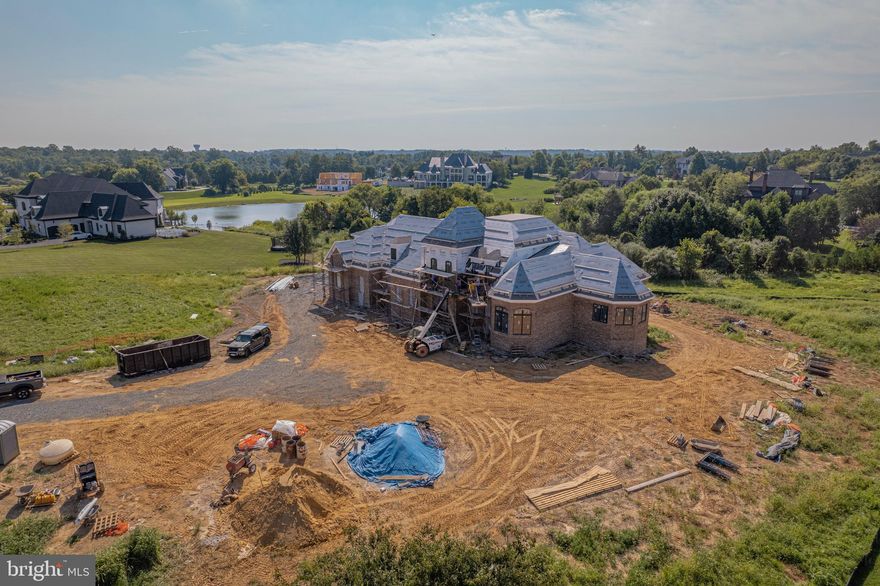 Welcome to this extraordinary new construction estate, where there is still time to select options to customize your forever dream home! Built by premier luxury home builder, Creighton Enterprises Custom Homes, this one of a kind masterpiece exemplifies sophistication, elegance, and superior craftsmanship within every detail. Sited on a premium 3-acre lot in the sought after community of Grenata, remarkable details of this home include a stately brick exterior; oversized three-car side-load garage; a three-level elevator; sweeping and floating solid wood, curved staircase accessing all levels of the home; Gallery hall with built-in art niches directing you to the Library and the highly desired main-level Owner's Suite with oversized walk-in-closet and En-Suite that includes a soaking tub and spa shower; grand two-story Great Room allows your entertaining space to flow seamlessly to the outdoors where you will enjoy the open deck, screened terrace and breathtaking views; gourmet entertaining and Chef's Kitchen with professional grade appliances including Wolf gas double oven and range with six burners, Sub-zero refrigerator/freezer, 8' center island, granite counters; three Bedroom Suites on the upper level each serviced by its own private Bath; finished walk-out lower-level with Recreation and Game Room, Powder Room for guest's to use, Craft Room that could be utilized as a Guest Suite serviced by the full Bathroom; main-level Laundry Room; optional second Laundry Room and Kitchen on the lower level would create the perfect In-Law or Au-Pair Suite; a three-zone HVAC plus separate thermostat designated for just the Owner's Suite. Located just a short drive to downtown Leesburg shops and restaurants, Creighton Farms Country Club for the golf and tennis enthusiasts, Loudoun County Wine and Hunt Country, access to commuter routes (Dulles Green Way, Dulles Toll Road, Routes 50/7/28), minutes to Dulles Airport, and so much more. This spectacular, one of a kind property is waiting for you to make it your forever home!