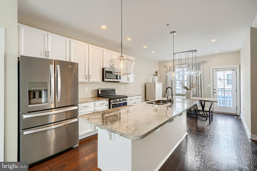 $5,000 lender credit available. Rarely available 4-level luxury townhome with a 2-car garage in sought-after Towson Manor Village! Nearly new and impeccably maintained, this home offers over 1,900 sq ft of sun-filled living space.

Luxury wide plank flooring span the lower and main levels, leading to a gourmet kitchen with upgraded countertops, stainless steel appliances, and a large center island with breakfast bar seating, and a spacious pantry.

The home features three bedroom, two primary bedroom suites, including a main suite with a private bath featuring double sinks and a glass-enclosed shower. Five total bathrooms, one on every level, with two ensuite baths provide exceptional comfort and flexibility.

The top level offers an additional large bedroom, full bath, and a rooftop balcony with stunning views of downtown Towson. The lower-level recreation room can serve as a 4th bedroom, home office, or flex space.

Conveniently located within walking distance to downtown Towson restaurants, shopping, and entertainment, plus a spacious 2-car garage with storage. Luxury, location, and low-maintenance living at its best.