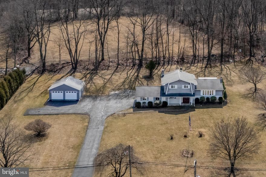 Escape to peaceful country living in this charming split-level home, nestled on 1.62 acres of serene land. With 4 bedrooms and 2 full baths, this home offers ample space for those seeking extra room. The lower levels feature a cozy family room with a fireplace, an office/bedroom, a full bathroom, and a three-season room off the family room. The second floor boasts a spacious living room that opens to the dining area with easy access to the kitchen and a covered deck. The third floor includes 3 bedrooms and another full bathroom. Hardwood floors are beneath the carpet on the second and third floors, offering great potential for a timeless look. With an oversized two-car attached garage and a separate two-car detached garage, there’s plenty of space for vehicles, hobbies, or additional storage. Enjoy outdoor gatherings on the covered deck. Located directly across from a local park, you’ll have easy access to outdoor activities. Though not recently renovated, this home is move-in ready, with fresh paint and well-maintained features.