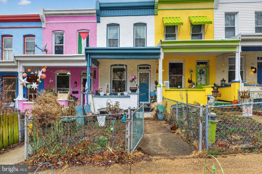 Welcome to 1120 Roland Heights Ave—right in the heart of the Hampden Historic District, one of the most vibrant and sought-after neighborhoods in Baltimore.

Situated on one of Hampden’s most colorful rows of painted homes, this charming Hampden/Medfield townhome blends timeless character with thoughtful updates. Enjoy your morning coffee on the inviting front porch, surrounded by beautifully maintained gardens that truly come to life in June—adding an extra layer of charm and color to the home’s already vibrant setting. Front and back yards offer the perfect space for relaxing or entertaining.

Inside, you’ll find beautiful original hardwood floors, an updated kitchen (2018), and a renovated bathroom featuring a brand-new vanity (2025) and a skylight that fills the space with natural light. The drop ceiling has been removed and replaced with clean drywall (2025), enhancing the home’s open feel. Tilt-in windows (2009) make for easy cleaning and everyday convenience. A bright bonus sunroom just off the kitchen overlooks the backyard—ideal for a home office or cozy retreat.

Step outside to your private backyard oasis, complete with a driveway for off-street parking—a rare and valuable feature in Hampden.

The expansive lower level offers incredible potential, featuring a rough-in for an additional bathroom and plenty of space to finish to your needs.

Additional major updates include: water heater (2017) and gas boiler (2016), offering peace of mind for years to come.

Located just steps from Hampden’s beloved shops, restaurants, parks, and local hot spots, with convenient access to Hampden schools, this home puts you right in the center of Baltimore’s thriving arts district.

Colorful, charming, and completely move-in ready—this is Hampden living at its best. Showings begin Saturday, 3/21!