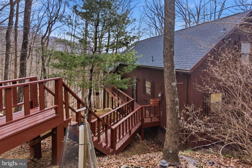 A waterfront cabin with 180 degree views of the mountains in the winter.  Enjoy this cozy, secluded cabin on the clean, Cacapon River relaxing on the extensive screened porch.  A loft bedroom with a separate bath, a main level bedroom, bathroom/laundry and the openness of the kitchen and great room.  The corner woodstove will add ambiance and warmth on cool nights.  Relax in the hot tub while enjoying the fresh mountain air.  The roof was replaced in December of 2025.  Freshly painted with new floors, kitchen counter top, new stainless appliances, two mini splits for additional comfort. Several fruit trees are planted on the upper meadow portion of the lot with a small storage shed and even more views from this vantage point.
Come and relax only 5 minutes to the center of Historic Berkeley Springs, the country's first spa, where you can enjoy the warm springs, shopping and restaurants.
Professional photos in a few days.