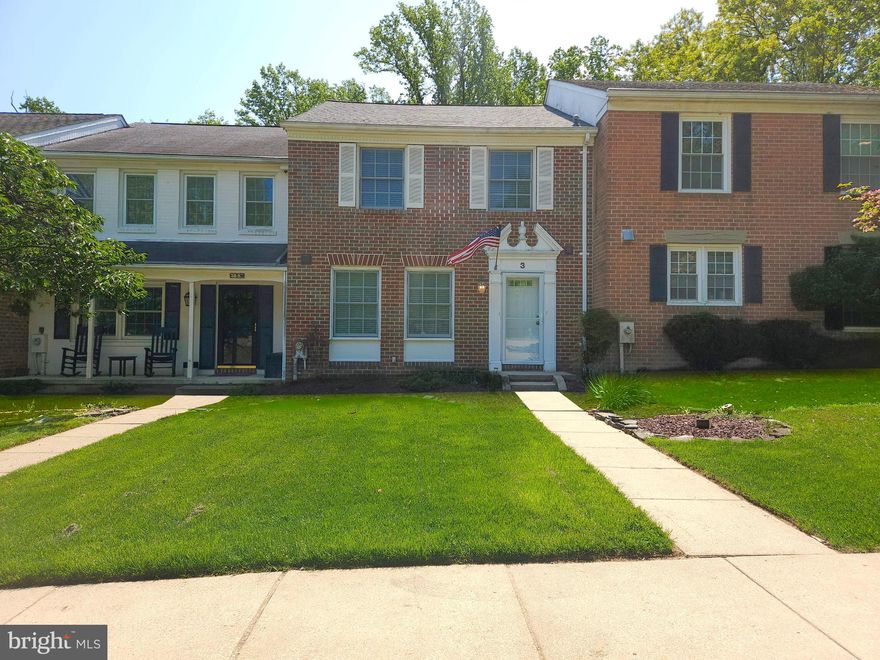 Welcome to this beautifully maintained brick townhome in the highly desirable community of Mays Chapel. This spacious home offers three generously sized bedrooms and three full baths plus one-half bath on the main level.  The main level has hardwood floors throughout the open living and dining areas, creating a warm and inviting atmosphere perfect for entertaining. The finished lower level expands your living space with a cozy family room with a fireplace ideal for relaxing along with a versatile bonus room that can serve as a home office, guest space, or fitness area. Step outside to the rear deck, perfect for outdoor dining, morning coffee, or simply enjoying peaceful surroundings. Some images have been virtually staged.