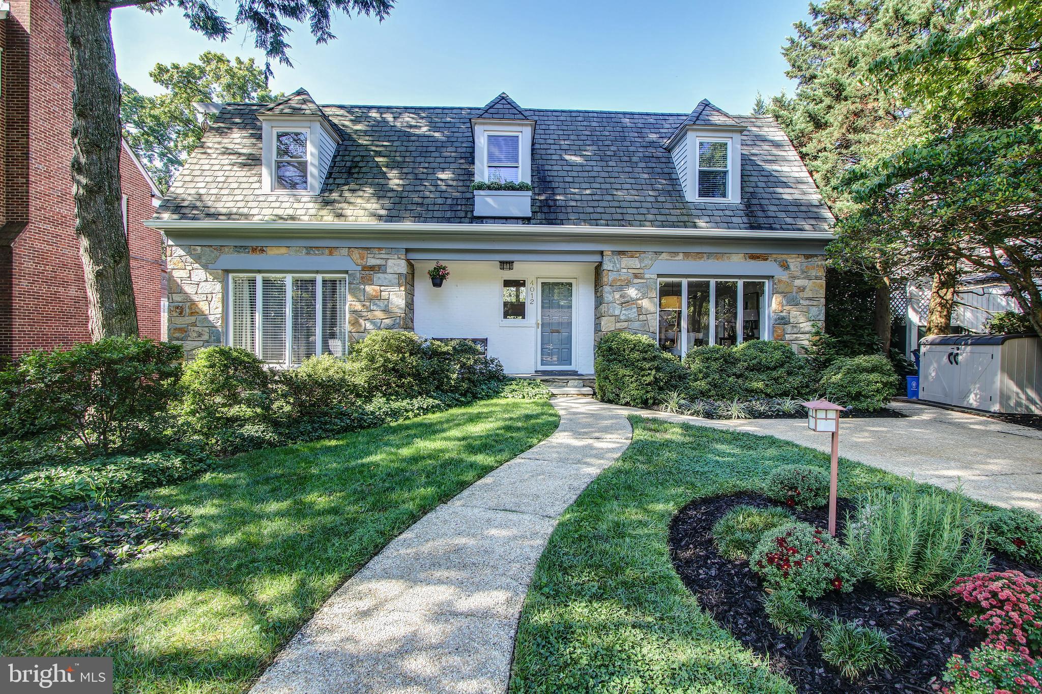 Offers due Tues 9/17 4pm -Escape the ordinary! Rare offering of a Cape Code re-imagined in dramatic contemporary form. Tucked away in a quiet residential neighborhood adjacent to a Country Club and shopping, and a quick ride into DC.This unique home encompasses approximately 3000 sq feet of living space on three levels, with soaring ceilings, floor to ceiling windows and a floorplan well-suited to entertaining. With 4 bedrooms, 3.5 baths and the master suite on the main level, the home suits all lifestyles.From the moment you enter the front door, your eyes will be drawn to the spectacular living room, featuring vaulted ceiling, a dramatic stone wall and floor to ceiling windows that bring in backyard views and invite you to enjoy time on the expansive composite deck. The open living room leads to a cozy sitting room with wet bar, facing a sliding door to the deck. Spacious dining with floor to ceiling windows that easily welcomes 10 guests. The upgraded and bright eat-in kitchen offers quartz counters, Shaker-style cabinets, a pantry closet, breakfast bar, double wall oven, and a five-burner gas cooktop--all new suite of stainless steel appliances. The breakfast area faces the tree-tops and deck. The generously sized master suite boasts two large closets, and an ensuite bath with a gorgeous tiled shower and two sinks. The upper level features two ample bedrooms. They share a large hall bathroom with cheerful tile and two sinks.The walk-out lower level provides ample space for recreation (with wet bar), games and TV-watching, around a gas fireplace. The 4th bedroom with large windows and full bath makes this a perfect au pair or in-law suite.