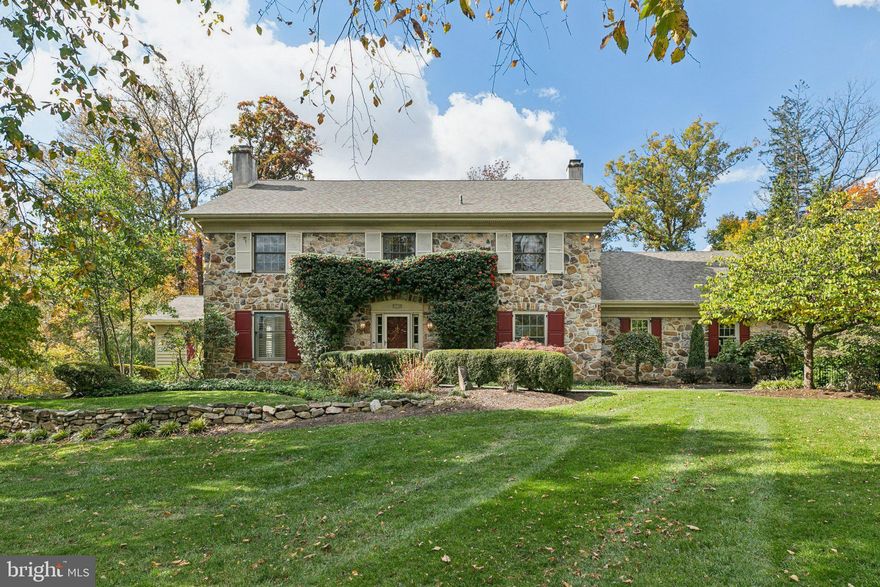 Located on a quiet cul-de-sac in the heart of Blue Bell, is this stately home offering 4 bedrooms, office, 2 full and 2 half baths, finished basement, 2 car garage, expansive back yard, impeccable landscaping and timeless charm. 1125 Blyth Court is a classic stone-front home that beautifully blends traditional character with modern updates. Set back from the street on a large, landscaped lot surrounded by mature trees, the property offers both privacy and exceptional curb appeal. Enter the front door to the foyer with hardwood floors, crown molding, and a convenient coat closet with a nearby half bath. To the left, the living room features large windows, a wood-burning fireplace, and recessed lighting. To the right, a versatile office includes built-in shelving and a closet, perfect for working from home or accommodating guests. The renovated chef's kitchen is the centerpiece, designed for both everyday living and entertaining. Highlights include an oversized island with seating for up to eight, Thermador range and double ovens, a Café refrigerator, and abundant cabinetry. Thoughtful touches such as a coffee bar, wet bar with sink and wine fridge, and open wood shelving around the original stone fireplace make this space both functional and warm. A bright dining nook with bay windows overlooks the deck, while a formal dining room connects seamlessly to the main living areas. A step-down family room adds even more space to gather, featuring high ceilings, tons of windows, and sliding glass doors that open to a large, tiered deck. The fenced backyard feels like a private retreat with mature landscaping, a pond with two small bridges, a fire pit area, and stone walkways. Upstairs, you’ll find four spacious bedrooms, each with generous closet space. The hall bath includes a double vanity, tiled floors, soaking tub, and separate shower. The primary suite stands out with multiple walk-in closets and a flexible sitting or dressing room. Its ensuite bath features dual vanities, a soaking tub, water closet, and a large glass steam shower with pebble tile flooring, and rain shower head, all framed by windows overlooking the yard. The finished lower level extends the living space with a temperature controlled wine cooler, a large open area with sliding doors to the backyard, and a separate unfinished section ideal for storage. Additional features include a two-car side-entry garage with extra storage, a second half bath, laundry room and mudroom from the garage entrance, and multiple hallway closets for convenience. Recent updates include a fully renovated kitchen, new appliances, freshly painted interiors, new stair runner and carpet in primary bedroom closet, newly installed kitchen and office windows, new HVAC system (Spring 2025), and refreshed light fixtures in the foyer and upstairs hallway. The basement was refinished in Fall 2024 with new carpet, drywall, and paint. This home is situated within the highly regarded Wissahickon School District, this home offers a rare combination of space, privacy, and accessibility, just minutes from Blue Bell’s best shopping, dining, and major commuter routes.