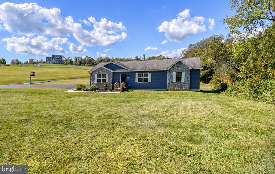 Only 10 years young, this beautiful custom-built rancher offers the perfect blend of modern comfort and peaceful country living — all while being just minutes from local conveniences!  Sitting on a private 1.39-acre lot with no restrictions, this home is ready for you to move right in and enjoy.  Step inside to discover fresh professional paint and new carpet throughout, a brand-new HVAC (2024), new hot water heater (2025), and new washer & dryer (2024)!  The gleaming Luxury Vinyl Plank flooring (2023) adds a touch of elegance, and the freshly blacktopped driveway (2025) welcomes you home in style.  The open floor plan features a spacious living room with a cozy electric fireplace, a large and bright kitchen with ample storage, and a convenient laundry area with a pantry located right off the side entrance.  The primary bedroom suite is spacious, featuring a large walk-in closet and a generously sized en-suite bath.  Two additional bedrooms and a second full bathroom provide ample space for family or guests.  Downstairs, you’ll find a full poured-concrete basement — the entire footprint of the home — with a rough-in for a 3-piece bath and an egress window to the backyard, offering endless possibilities for expansion or recreation space.  The property also features a low-nitrogen BAT septic system, adding efficiency and peace of mind. Don’t miss this lovingly maintained home in a gorgeous rural setting — offering the best of both worlds: country serenity and modern convenience!