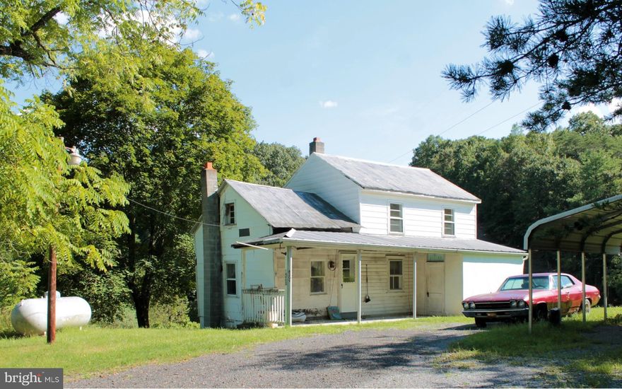 1800s era farm house nestled in one of the valleys this 35.36-acre property offers. The home includes central air and heat on the main floor, full bath, main floor bedroom or den, screened porch, and walk-in cold storage, perfect for hunters.  Property includes several outbuildings in average condition. Acreage is mostly wooded w/trails, streams & rolling terrain, open space for crops & animals.