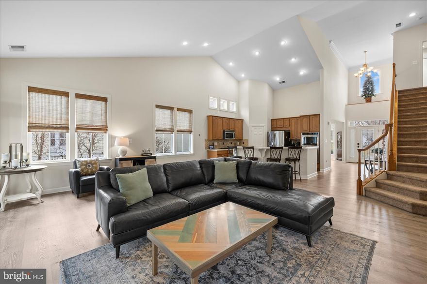Welcome to your coastal retreat in The Reserves at Lewes Landing! This three-bedroom, three-bath home offers 2,700 square feet of living space on a half-acre lot that backs to peaceful, community-owned woods, providing both privacy and a natural setting. The home features soaring two-story ceilings and an open, light-filled layout centered around a propane fireplace with a striking stone surround in the family room. The kitchen flows seamlessly into the main living area, making it ideal for everyday living and entertaining, while a separate formal dining room offers an elegant space for special occasions. The primary suite is conveniently located on the main level and includes a bathroom with dual vanities, a soaking tub, and a separate shower. A second bedroom and full bath are also located on the main floor, offering flexibility for guests or an office. Updated luxury vinyl plank flooring runs throughout the main living areas and bathrooms. Upstairs, you’ll find a loft overlooking the family room, a third bedroom with a full bath, and an additional storage room for all your extra needs. A bright sunroom addition, completed six years ago, overlooks the fully fenced backyard, which also includes a garden shed and plenty of room to relax, play, or entertain. A deck just off the sunroom extends the living space outdoors. The HOA allows in-ground pools (with ARC approval), making it the perfect setting to create your own backyard oasis. The two-car garage provides ample parking and storage, and the HVAC system was replaced three years ago for peace of mind. The Reserves at Lewes Landing offers a pool, clubhouse, pickleball courts, and is close to shopping, dining, and the main campus of Beebe Hospital. With its generous space, thoughtful upgrades, and unbeatable location, this home is the perfect blend of comfort, convenience, and coastal living.
