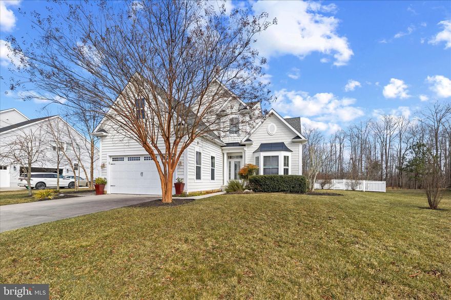 Welcome to your coastal retreat in The Reserves at Lewes Landing! This three-bedroom, three-bath home offers 2,700 square feet of living space on a half-acre lot that backs to peaceful, community-owned woods, providing both privacy and a natural setting. The home features soaring two-story ceilings and an open, light-filled layout centered around a propane fireplace with a striking stone surround in the family room. The kitchen flows seamlessly into the main living area, making it ideal for everyday living and entertaining, while a separate formal dining room offers an elegant space for special occasions. The primary suite is conveniently located on the main level and includes a bathroom with dual vanities, a soaking tub, and a separate shower. A second bedroom and full bath are also located on the main floor, offering flexibility for guests or an office. Updated luxury vinyl plank flooring runs throughout the main living areas and bathrooms. Upstairs, you’ll find a loft overlooking the family room, a third bedroom with a full bath, and an additional storage room for all your extra needs. A bright sunroom addition, completed six years ago, overlooks the fully fenced backyard, which also includes a garden shed and plenty of room to relax, play, or entertain. A deck just off the sunroom extends the living space outdoors. The HOA allows in-ground pools (with ARC approval), making it the perfect setting to create your own backyard oasis. The two-car garage provides ample parking and storage, and the HVAC system was replaced three years ago for peace of mind. The Reserves at Lewes Landing offers a pool, clubhouse, pickleball courts, and is close to shopping, dining, and the main campus of Beebe Hospital. With its generous space, thoughtful upgrades, and unbeatable location, this home is the perfect blend of comfort, convenience, and coastal living.