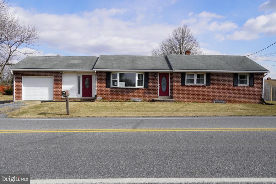 Fall in love with this all brick ranch home!!! This home includes 3 bedrooms and an updated kitchen and main bathroom! Enjoy the 1st floor laundry,  half bath, and heat pump with central air that were added in 2015! Relax in the back yard that is completely fenced in.  The home also comes with an attached one car garage, a detached two car garage, and a large driveway for additional parking.  Commercial zoning is possible.  Currently zoned Suburban Residential which allows the owner to operate a business out of the home. Don't wait, this home be yours!