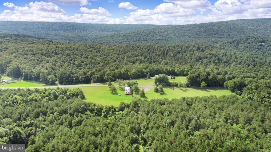Here is a rare opportunity to own 159 acres in Perry County. North East Madison Twn. Has no zoning. A 2 story colonial home could serve many purposes. There is almost a mile of road frontage on Route 850. There is over a mile of border to thousands of acres of State Game Lands creating endless hunting. A great property for your personal hunting or bring the hunting camp. Lots of paths and trails for the ATV's.Thinking outside the box might include a campground possibility , grazing area for the horses, sheep and goats. For agriculture this property could house commercial poultry facilities. There is some timber.  A lot of the area is timber and brush growth due to not being farmed for many years. This provides great cover for wildlife. The views of the surrounding mountains are spectacular. Relax on the deck and enjoy the wildlife appearing in the summer evenings. A great spot to sit by a fire on a winter evening with the snowflakes drifting past the windows. Also walk on paths that are similar to when the first settlers passed through to adjoining valley encountering hostile natives.