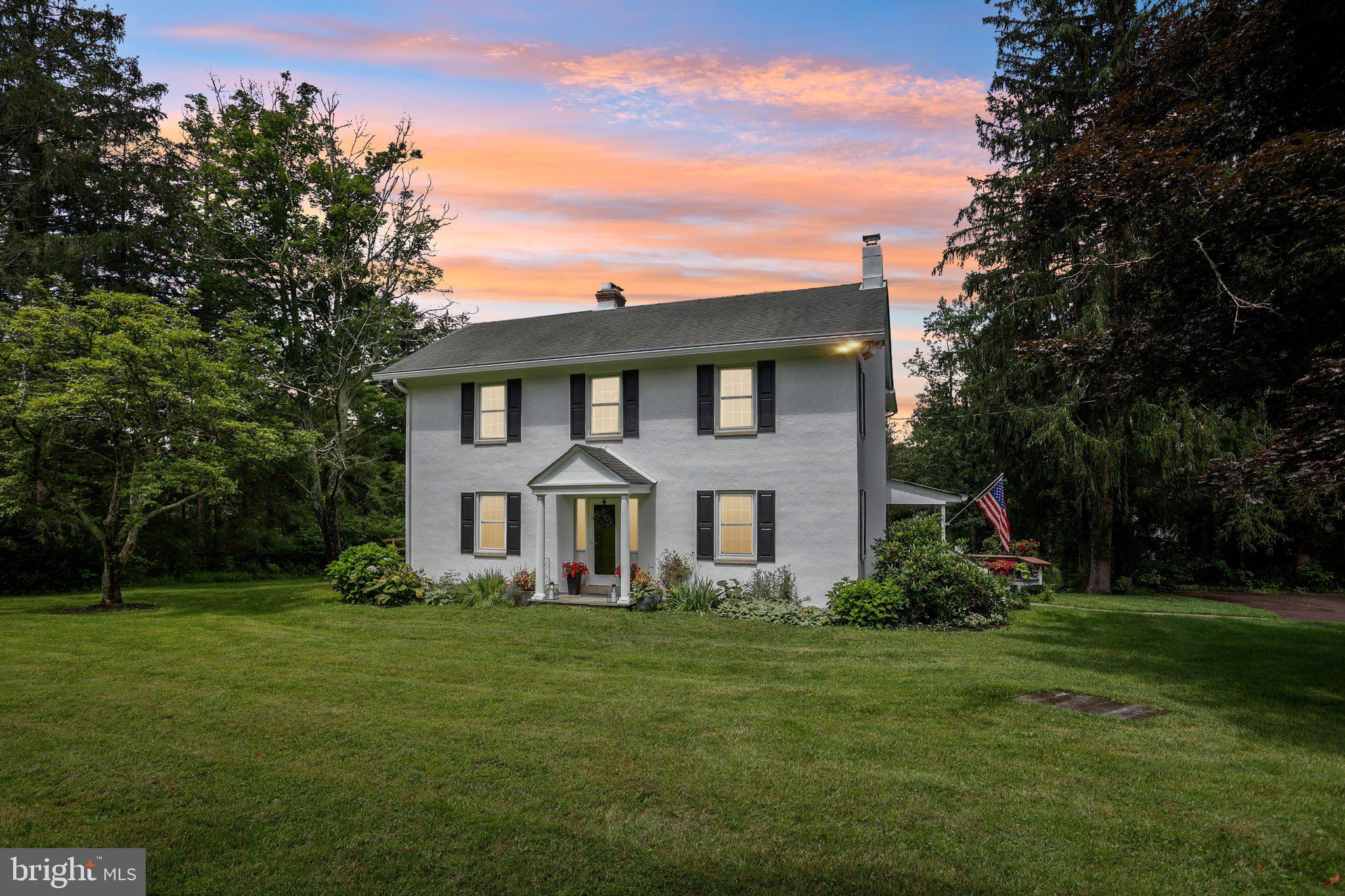 Welcome to 2070 Trumbauersville Road where stunning, palatial, breathtaking are just some of the words you will use as you gaze upon over 30 acres of swaying fields of grass, spring fed ponds and towering woods. This wonderful 5 bedroom home boasts a classic Pennsylvania farmhouse look with all the updates and modern amenities one would expect. Set above the rolling fields, the home welcomes you in where you'll first notice original hardwood floors throughout and Hickory wood joist construction. The foyer is flanked by a cozy family room and the formal living room. The renovated kitchen boasts gas cooking, granite countertops, a bar height countertop, a coffee station nook, a walk-in pantry, and a kitchen desk with a view. A quaint covered porch off the kitchen is the perfect spot for morning coffee or dining al fresco. Enjoy your meals overlooking the sprawling property from the full wall of windows in the dining room. The upper floor offers four secondary bedrooms which are served by an updated full hall bath. The primary bedroom provides a lovely view of the fields behind the home. The newly renovated ensuite features a frameless glass shower and modern fixtures. The exterior is equally impressive, boasting a new huge tiered deck for large gatherings and enjoyment of the spectacular heated saltwater swimming pool added in 2020. Parking and storage are a breeze with the property's rustic three car carport. Further down the property sits a versatile cottage/garage space with two car stalls and another carport, spanning approx. 1,200 square feet with a large 15x22 multi-purpose loft on the second floor (currently a home office and gym). Some additional highlights include 5 heating zones, a full house A/C, cast iron baseboard heat, and even the chicken coop has electric. The current owners have lovingly updated and maintained the home by converting to a propane gas furnace, recently added a water softener, replaced the well pump, replaced water pressure tank in 2023, and installed a basement locker room for whatever use you can imagine. This property is just a short drive from the quaint village of Trumbauersville and tons of shopping on Route 309. With easy access to the PA Turnpike, Route 309, and I-78 as well as Lehigh and Philadelphia Airports, this home is a commuters dream. Property has been approved under Act 319.