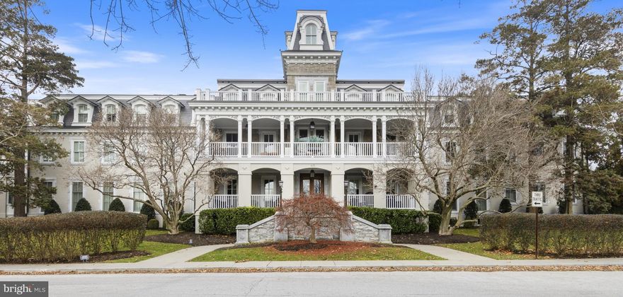 Nestled in the heart of charming Wayne, this beautifully updated condo is part of
the landmark “Louella House.” Originally commissioned as a family estate for one
of Wayne’s first settlers, Louella House was later renovated by award-winning C.F.
Holloway Builders. Walk through the unit’s grand mahogany front door and
prepared to be wowed, from the soaring 11-foot ceilings and wide plank hardwood
floors to the designer light fixtures, plantation shutters and custom moldings
throughout. Natural light streams into the entryway and front family room via an
oversize, deep-silled window and adjacent glass patio door, highlighting the gas
fireplace and custom built-ins. An arched opening frames a sparkling white chef’s
kitchen with island seating, gas cooking, appliance garage, Subzero® paneled
refrigerator and tasteful tile backsplash. Just around the corner you’ll find a cozy
dining nook. Behind the front living area and separated by French doors sits a
bonus room that could easily function as a home office, gym or den. Continue
down the hallway to the updated full bath with Carrera marble tile, glass shower
door and interior linen closet. A bright and airy secondary bedroom sits just
beyond. The hallway ends at the glorious primary suite, featuring a large closet
with custom organization system and ensuite full bath with oversized arched
window, more Carrera marble, large shower and tub. The unit also includes direct
(private) access to an underground parking garage with two reserved spots plus a
spacious, covered patio off the family room—perfect for lounging and people
watching! Residents of Louella House enjoy numerous amenities, including a personal storage unit-approximately 6' x 13', billiard room with gas fireplace, party room and meeting space, exercise room,
bike storage and catering kitchen. The shops and restaurants of downtown Wayne
are mere steps away, and it’s a quick commute to downtown Philadelphia, the
airport and major medical centers. Don’t miss this opportunity to enjoy walkable,
carefree living at its finest.