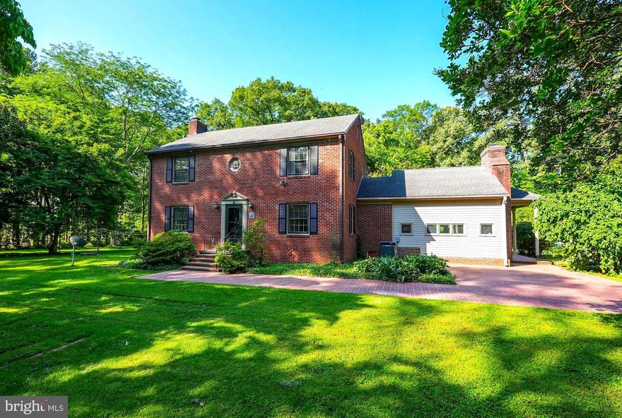 Discover this elegant all-brick colonial home, recently renovated to perfection. Set on a breathtaking 4.5 acres of private land, this property provides a tranquil and picturesque setting for your dream lifestyle.With its long, tree-lined driveway, elegant in-ground brickwork patterns, and expansive wraparound patio, this property exudes an estate-like feel—quiet, spacious, and tucked away, yet conveniently located just minutes from Dahlgren and Fredericksburg. Enjoy easy access to both Washington, D.C., and Richmond via Route 301, making it ideal for those seeking a peaceful living environment with a convenient commute.

Originally built in 1959 and cherished by only two families, this home beautifully blends classic architecture with modern updates. The newly renovated kitchen and dining area have been transformed into one large, airy space, featuring stunning white cabinetry, sleek black quartz countertops, polished nickel hardware, and brand-new appliances—perfectly designed for both everyday living and entertaining.

The main floor also includes a formal living room with a cozy fireplace, a den featuring a second fireplace, and a newly added main-level laundry room. The home has been refreshed with new paint throughout, creating a bright and inviting atmosphere. Additionally, a whole house generator has been installed, adding an extra layer of comfort and convenience.

Upstairs, the luxurious primary suite boasts a spacious walk-in closet and a beautifully renovated, spa-like bathroom complete with an oversized shower and double vanity. Two additional bedrooms and a second updated full bath complete the upper level, providing ample space for family or guests. The unfinished attic and basement offer extra storage or the potential for future projects.

Outside, the property continues to impress with its brick wraparound patio, circular driveway, and ample parking area. Whether you envision gardening, building a pool, entertaining guests, or simply enjoying the expansive outdoor space, this designer-like home offers timeless beauty, thoughtful updates, and a setting that truly stands out.

Don’t miss your chance to own this remarkable property—schedule your viewing today!