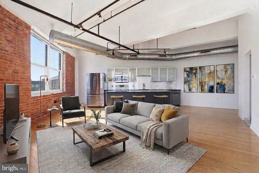Welcome home to 444 North 4th Street, Unit 407! This stylish loft-style 1-bedroom, 1-bath condo with a parking spot included in the heart of Northern Liberties blends modern design with effortless city living. Featuring 9+ foot ceilings, rich hardwood floors, and two full walls of windows, the open-concept layout is filled with natural light and offers a bright, airy feel throughout.
The kitchen is equipped with sleek appliances—all included—flecked countertops, ample cabinetry, a stainless steel refrigerator, and a wine fridge, flowing seamlessly into the spacious living and dining area—perfect for entertaining or relaxing at home. The generously sized bedroom includes large closets with custom built-ins, while the full bathroom showcases clean, contemporary finishes.
Additional highlights include in-unit stacked laundry, a private storage space with built-in shelving, and low monthly condo fees that includes parking!
This pet-friendly building offers top-tier amenities including a 24-hour front desk, gated parking, fitness center, bike storage, and on-site maintenance. The recently renovated lobby and exterior add to the building’s industrial-chic appeal.
Located between Northern Liberties and Old City, you’re just steps from some of Philadelphia’s best restaurants, cafes, shops, and nightlife, with easy access to I-95 and I-676. Don’t miss your opportunity to own in one of the city’s most sought-after neighborhoods!