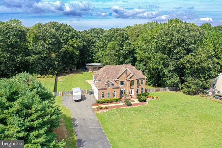 Welcome to 12551 Cleydael Blvd, situated in the prestigious Cleydael community in the heart of King George! This distinctive home has many unique features! There is a grand two-level main entry with a striking hardwood dual stairway. Upon entering, there is a private office with French doors and a formal dining room. The main level includes a bedroom complemented by a  full bathroom.  A large family room opens to a generous-sized breakfast room just off your incredible kitchen. The kitchen has tons of counter and cabinet space and a pantry! Corian counters, a great raised breakfast bar, and a nice refrigerator! We have to mention the wonderful natural light you will find in this home! Upstairs is incredible! The primary bedroom has three separate areas: your bedroom, a sitting room, and a sunroom or solarium to use as a gym or your morning room or office; it's filled with windows and has french doors that open from the sitting room. The primary bedroom also has a three-sided fireplace, trey ceilings, a massive walk-in closet, and a huge bathroom with a jetted Jacuzzi tub, separate shower, and dual vanity. Your second bedroom upstairs has its own walk-in closet and a full private bathroom. Bedrooms 3 and 4 share a jack-and-jill full bathroom with separate vanities and a shared shower/tub. Bedroom 4 has a massive walk-in closet with the coolest space for a reading nook or small playroom; you have to see! Downstairs, you have tons of space you could easily finish, but the owners have already completed a lovely full bathroom to compliment their walkout basement that takes you to a massive patio space and your pool!  Outside is a dream! You have 2.92 acres. The front yard is huge and level. The backyard is incredibly private due to the wooded privacy fence.  20x40 inground pool with it's own slide! There are tons of green space and a gentle slope, perfect for a garden, playing a game of soccer or football, or entertaining family and friends on your huge back deck or large concrete patio. You also have a massive 30x50 detached garage, truly a car collector's dream, or someone with a business or hobby that needs 1,500 square feet outside of the house. The detached garage has a separate electric meter, and HVAC; this one has it all! 2 post lift conveys in the garage. Nice storage shed. Schedule your private showing today.