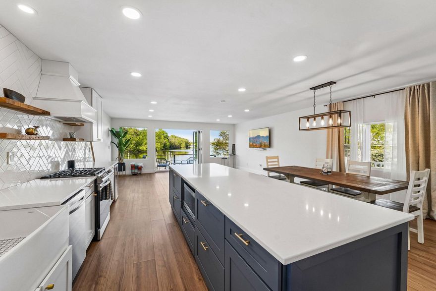 Just in time for summer!  This is your opportunity to own a charming waterfront bungalow on sought-after Schoolhouse Cove. Perfectly positioned for easy bay access, this beautifully renovated home offers the ultimate coastal lifestyle — where mornings begin with coffee on the water and afternoons end with sunset cruises from your own backyard.  Completely renovated from top to bottom, the home is truly move-in ready. Thoughtfully updated interiors blend classic bungalow charm with modern finishes, creating a light-filled, inviting space designed for relaxed waterfront living.  Outside, the property truly shines. A deep-water pier with boat lift - 12k pounds - means you can be out on the bay in minutes. Whether you enjoy fishing, cruising, paddleboarding, or simply spending long summer days on the water, this home makes it effortless. Dock your boat, step inside, and unwind.  If you've been dreaming of an easy, turnkey waterfront escape where the boating lifestyle is front and center, this is your chance to make it happen!