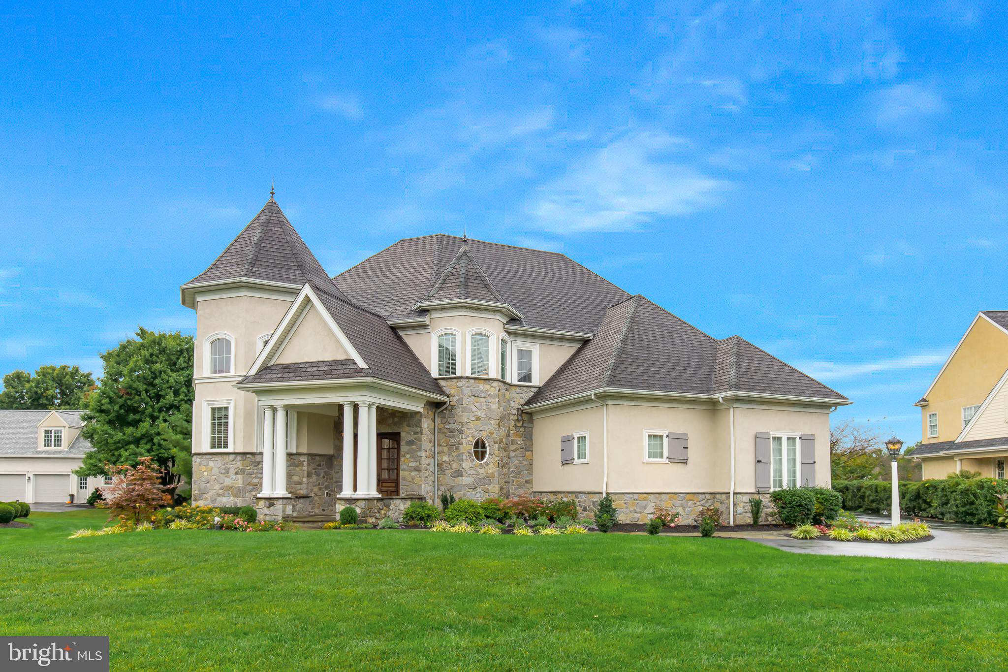 As you approach the stone walkway leading to the grand mahogany doors on the expansive covered front porch, it becomes clear this residence is a true work of art. The travertine-tiled entryway opens into a stunning 21-foot gallery, featuring illuminated moldings and niche alcoves. This luxurious home invites you into an airy family room with floor-to-ceiling windows, offering a breathtaking view of the backyard and the golf course. The open-concept design highlights a dream kitchen, complete with a 6-burner Viking range with a griddle, dual ovens, a built-in Viking refrigerator, dishwasher, and microwave. A large island, equipped with a vegetable sink, provides ample space for gatherings, while the walk-in pantry, adorned with an etched glass door, offers generous storage. For additional entertaining, there’s a butler’s pantry with a unique copper sink and beverage fridge, leading to the refined dining room with a double tray ceiling and ambient lighting. One of the home office options, located in the front turret, boasts abundant natural light and a soaring two-story tray ceiling, making workdays something to look forward to. The first-floor primary suite offers a serene retreat, complete with a luxurious en-suite bath. Outdoor living is equally inviting, with a screened porch featuring a gas fireplace and an expansive bluestone patio large enough for any social gathering with a gas firepit, perfect for S/mores. Overall a private setting for outside recreation while overlooking the black tee box on the 16th hole of the luscious bent creek golf course. The finished lower level provides extra space for a media room, along with two additional versatile rooms that can serve as bedrooms, a gym, playroom, or office. This impeccably maintained home, located in the prestigious Bent Creek Country Club community, is a rare find. Its convenient location near the vibrant areas of Lancaster and Lititz adds to its appeal. Set aside time to explore this remarkable property, as its many unique features deserve to be savored.